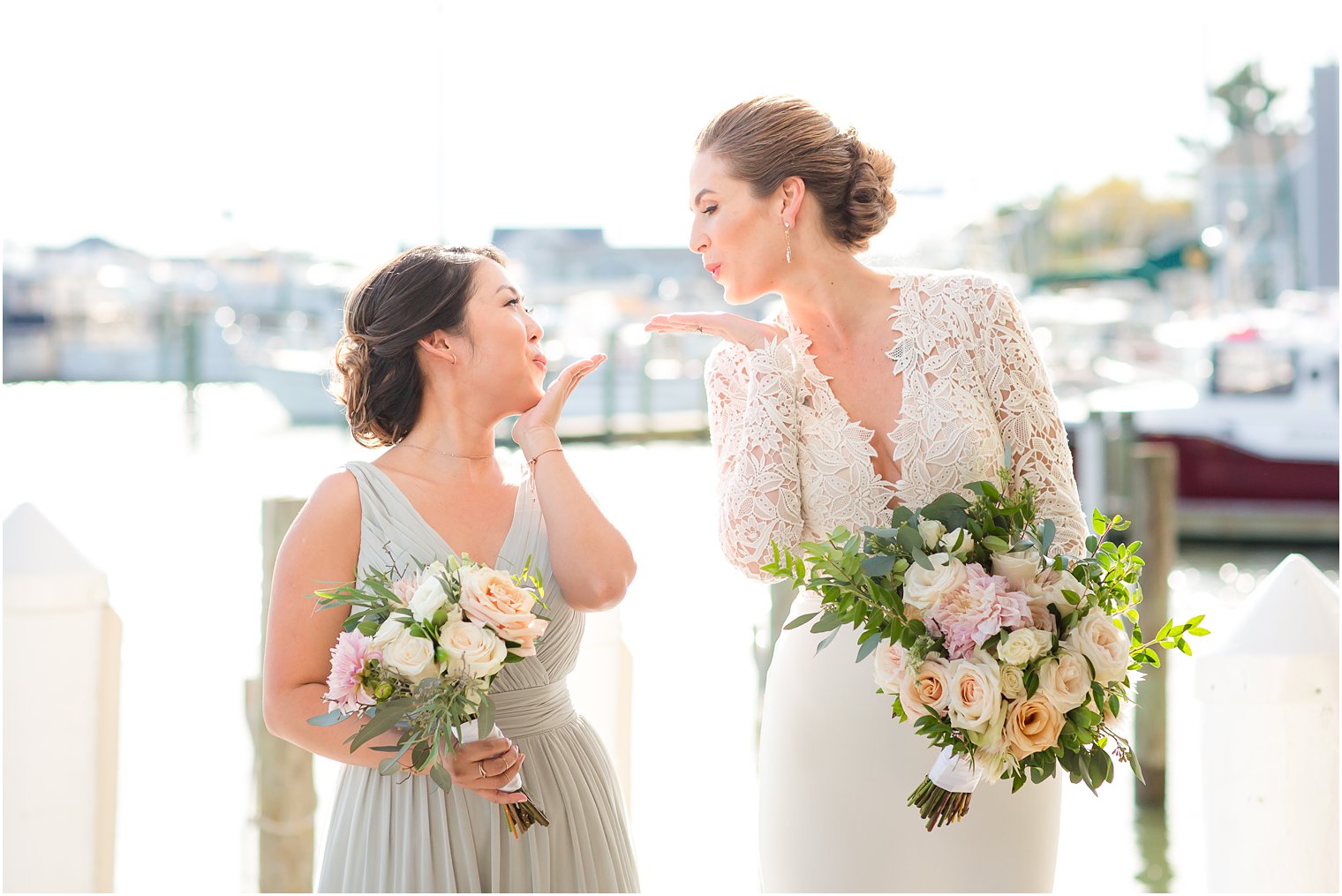 Bride and bridesmaid blowing kisses at each other