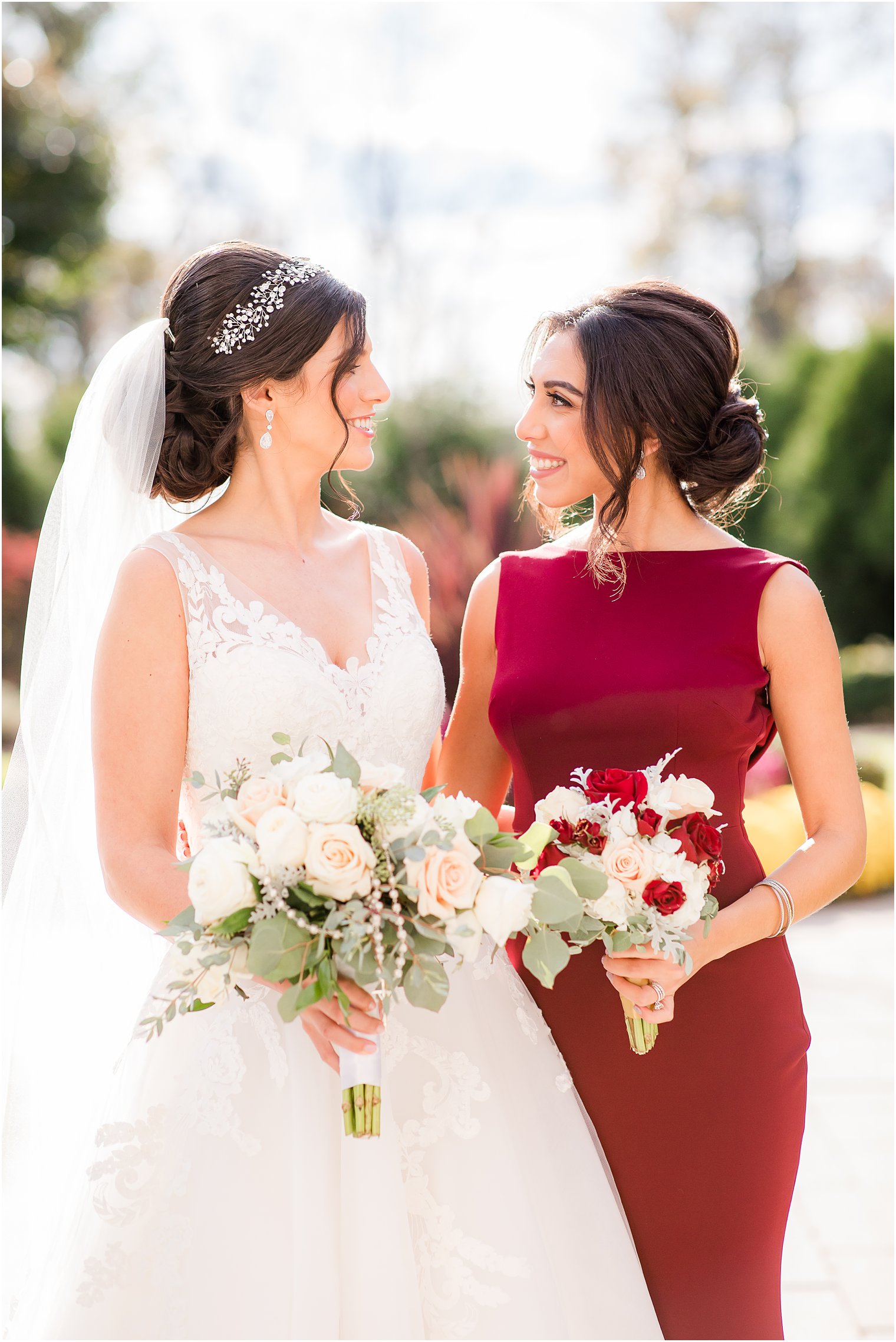 Bride and bridesmaid smiling at each other