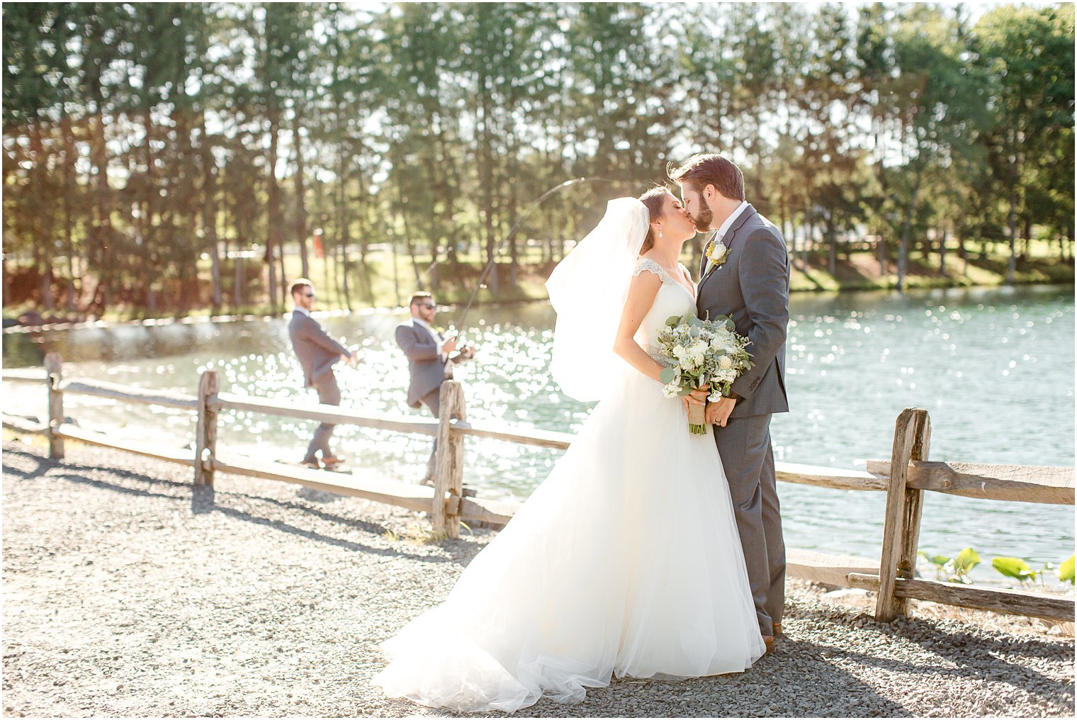 Groomsmen fishing with bride and groom