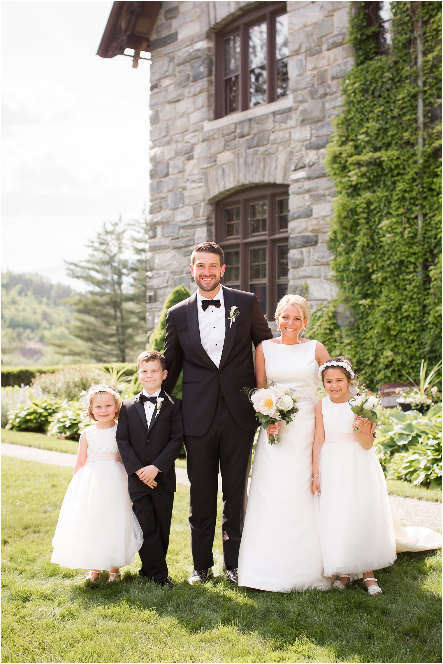 Formal photo of bride, groom, ring bearer, and flower girls