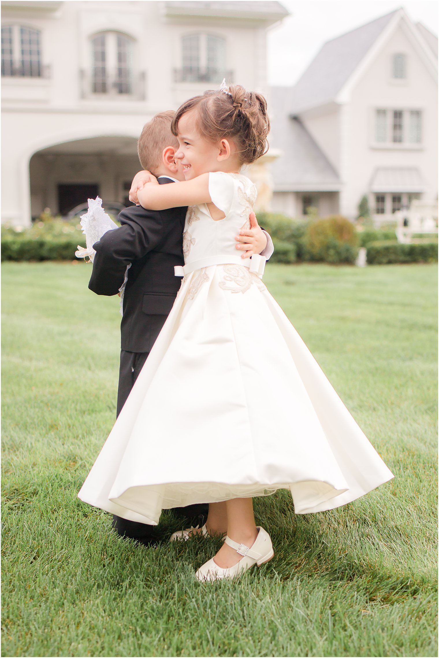 Flower girl hugging ring bearer