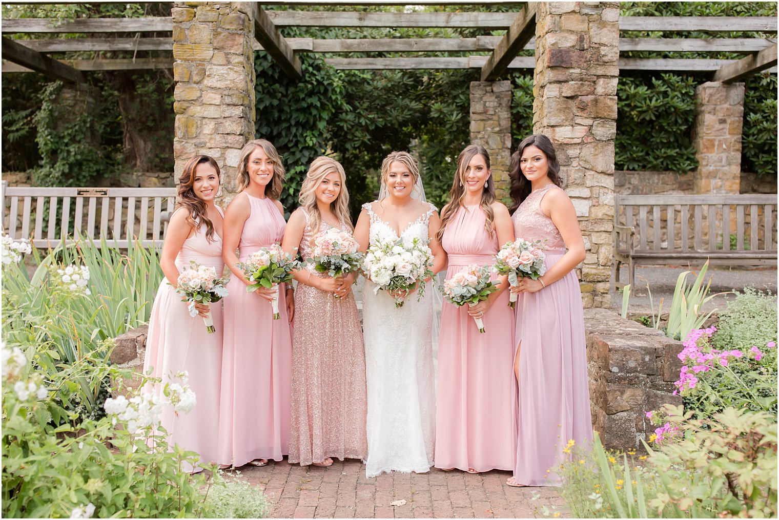 Bridesmaids wearing pink at Cross Estate Gardens for an Olde Mill Inn wedding