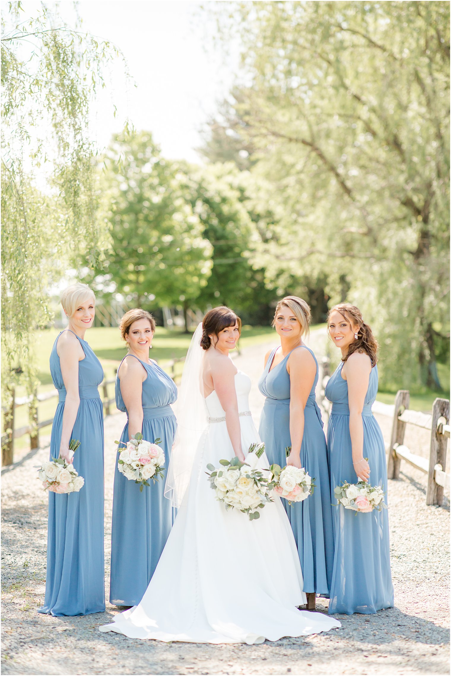 Bridesmaids wearing blue at Windows on the Water at Frogbridge