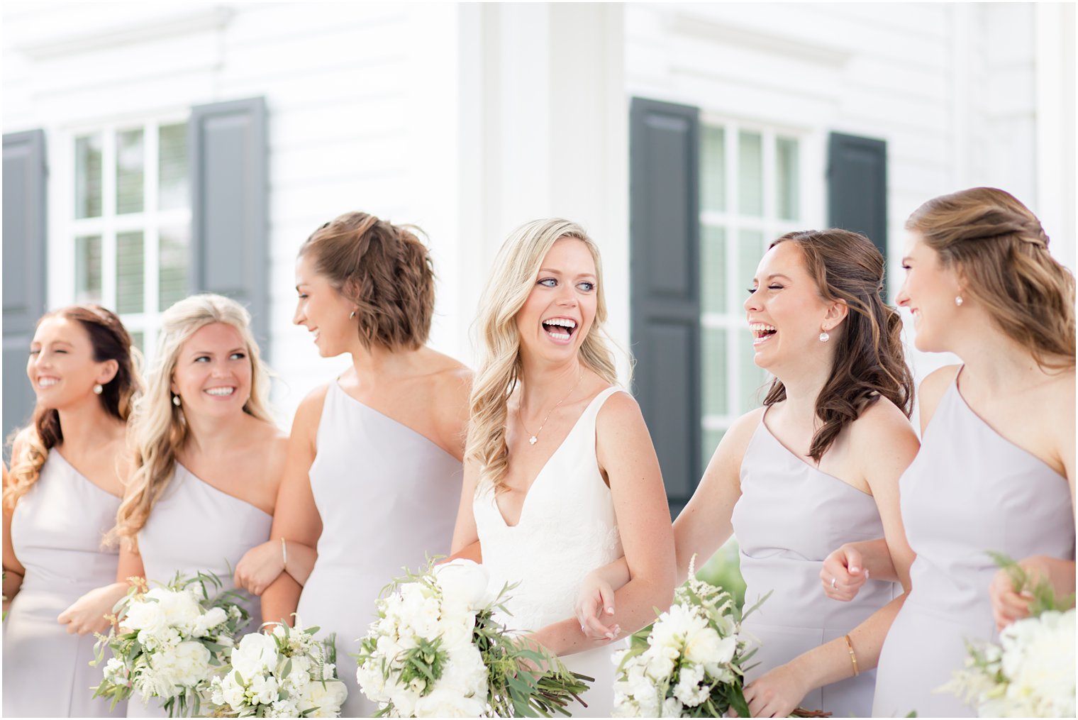 Candid photo of bride smiling at bridesmaids