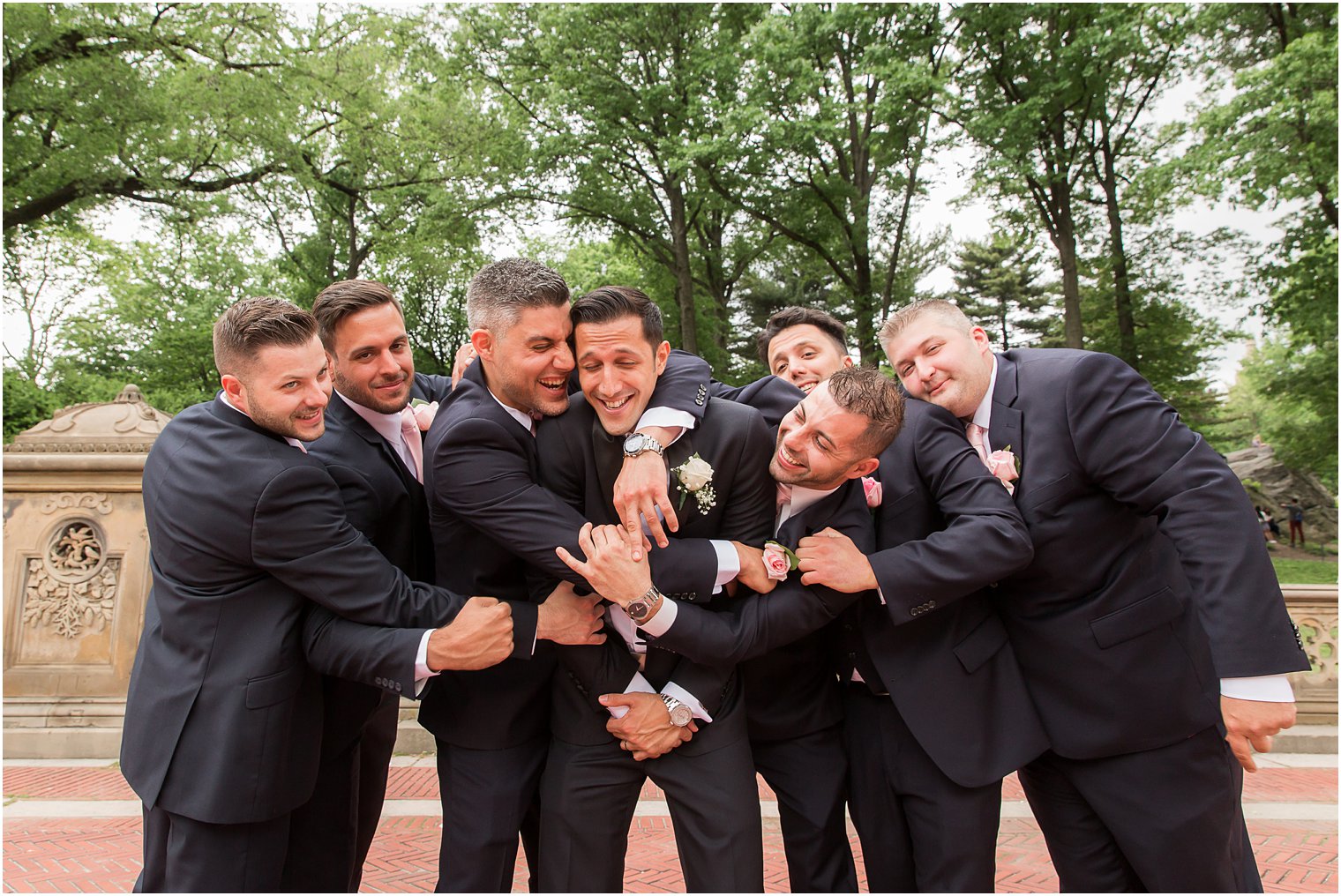 Groomsmen hugging groom