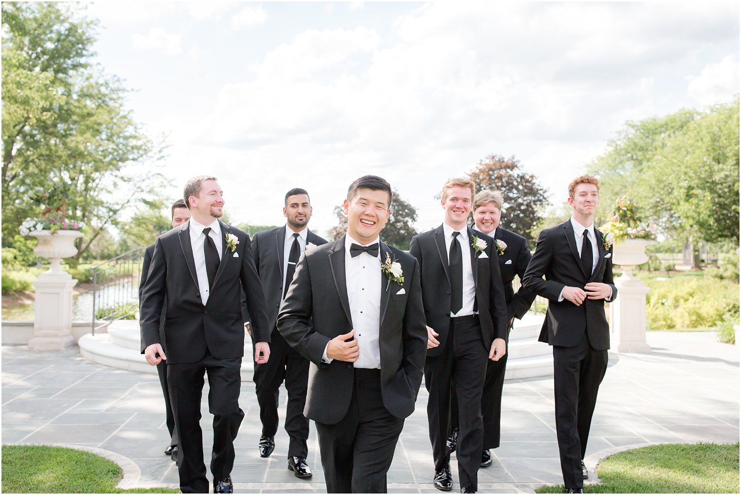 Candid photo of groom walking with groomsmen