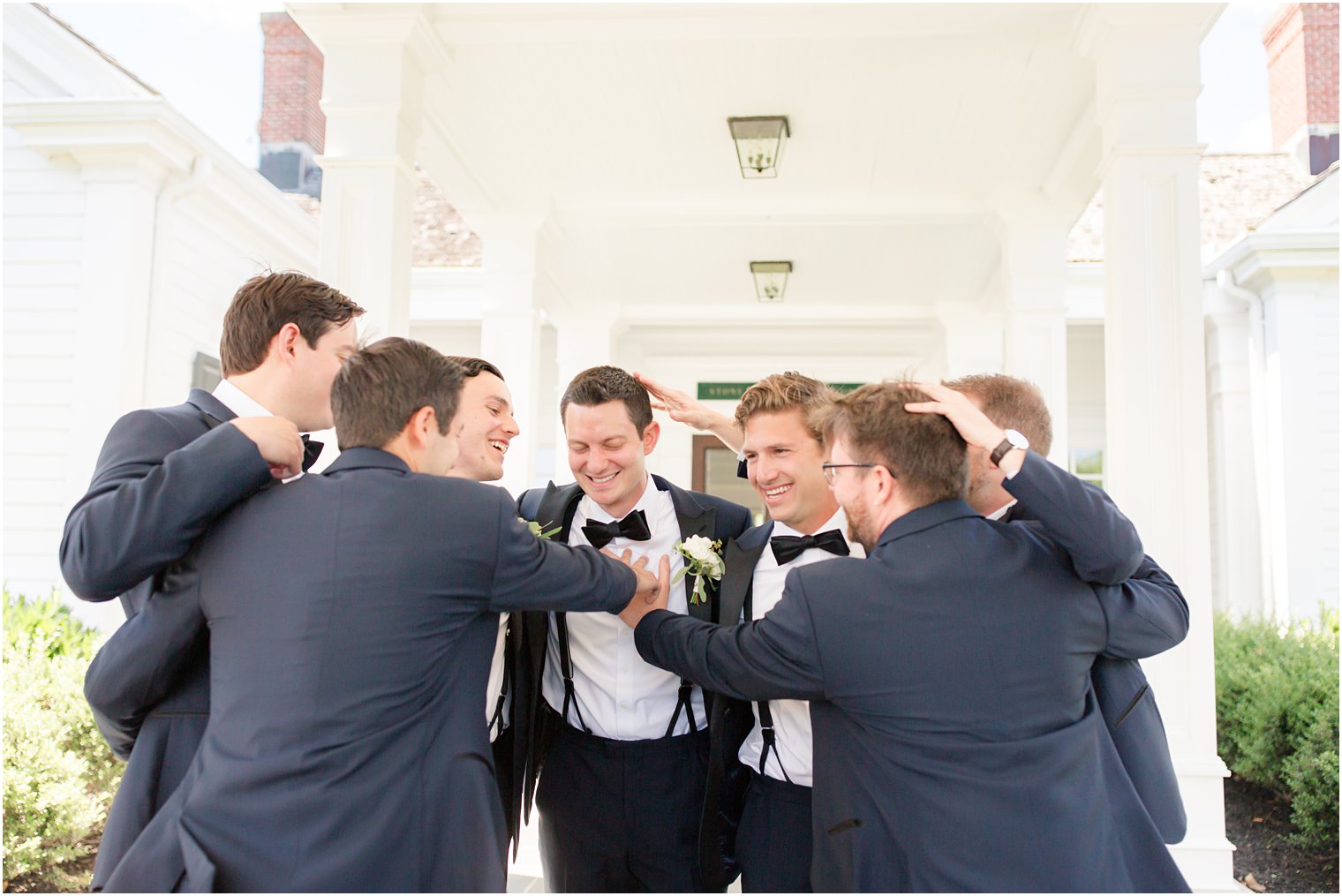 Groomsmen hugging groom