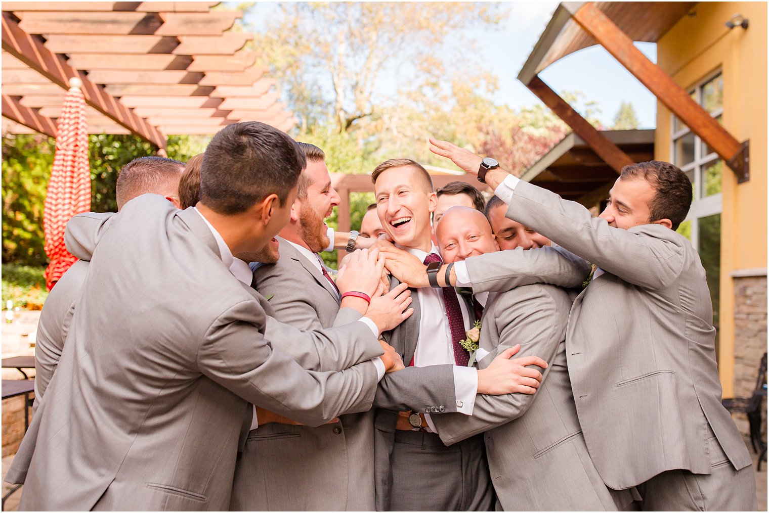 Groomsmen hugging groom