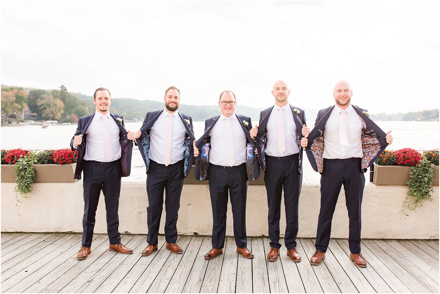 Groom and groomsmen showing off custom suits