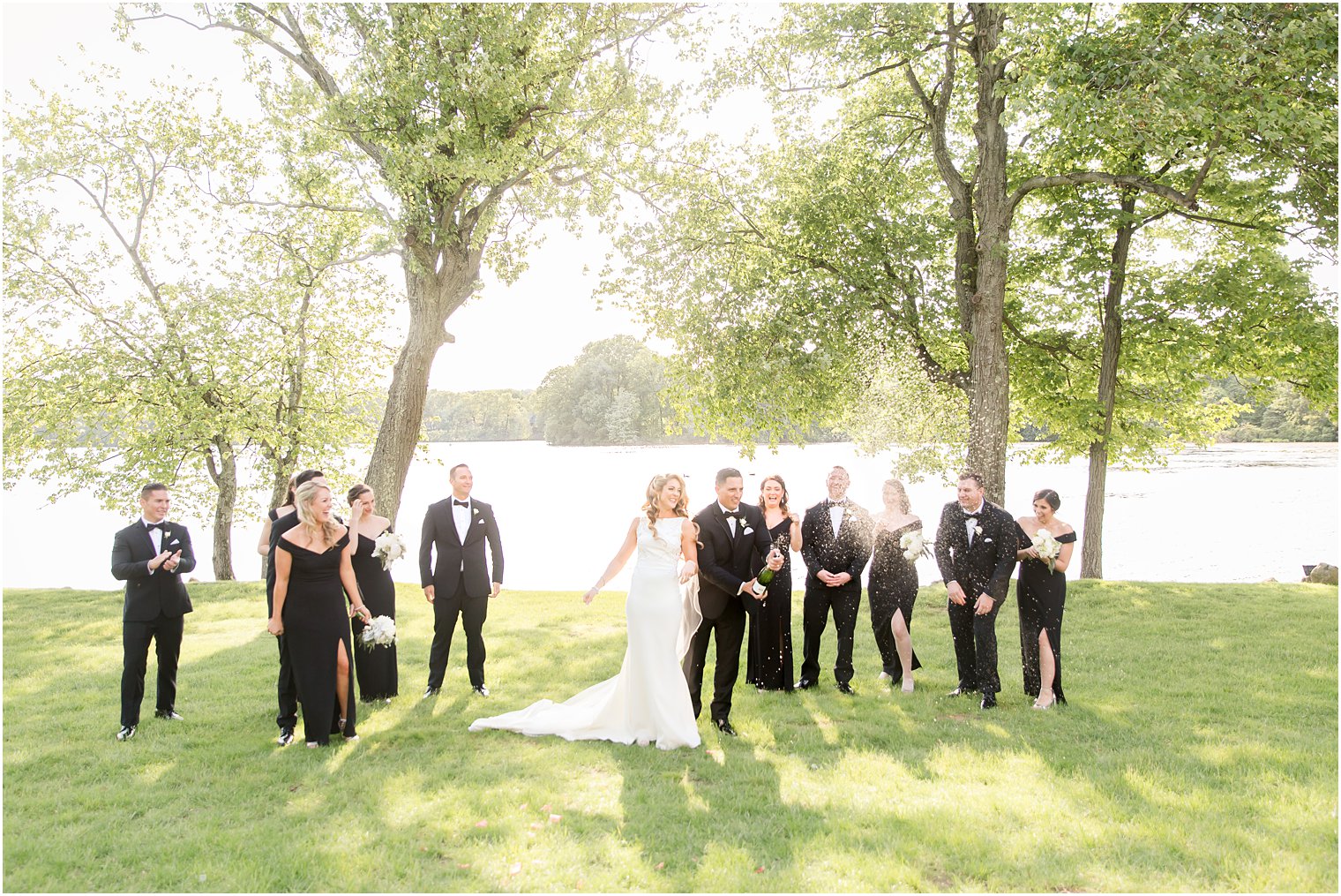 Bridal party opening bottle of champagne