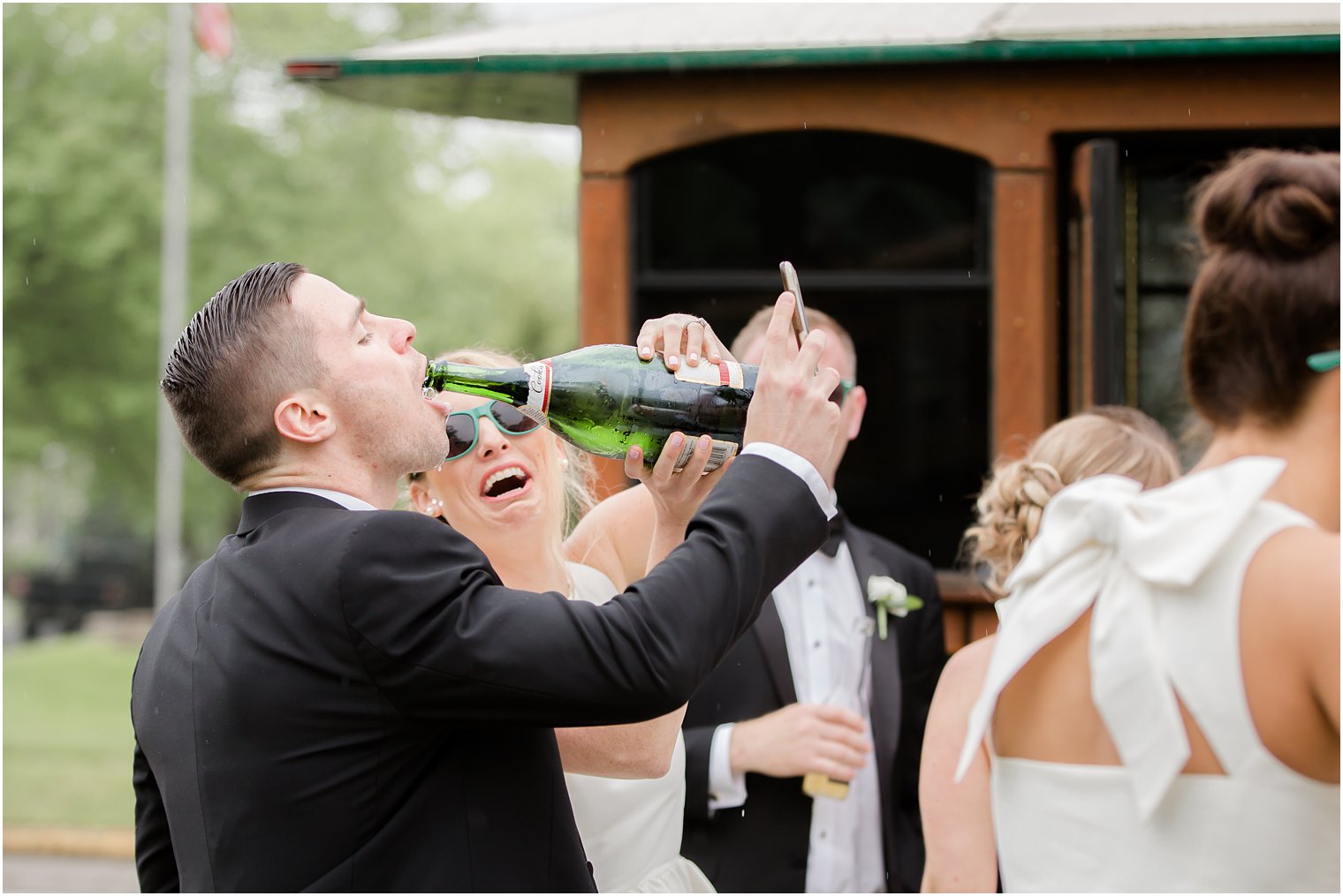 Groomsman drinking champagne