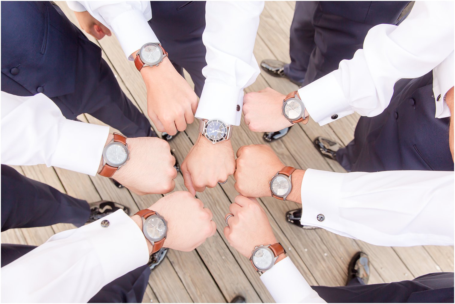 Groom and groomsmen showing off their watches