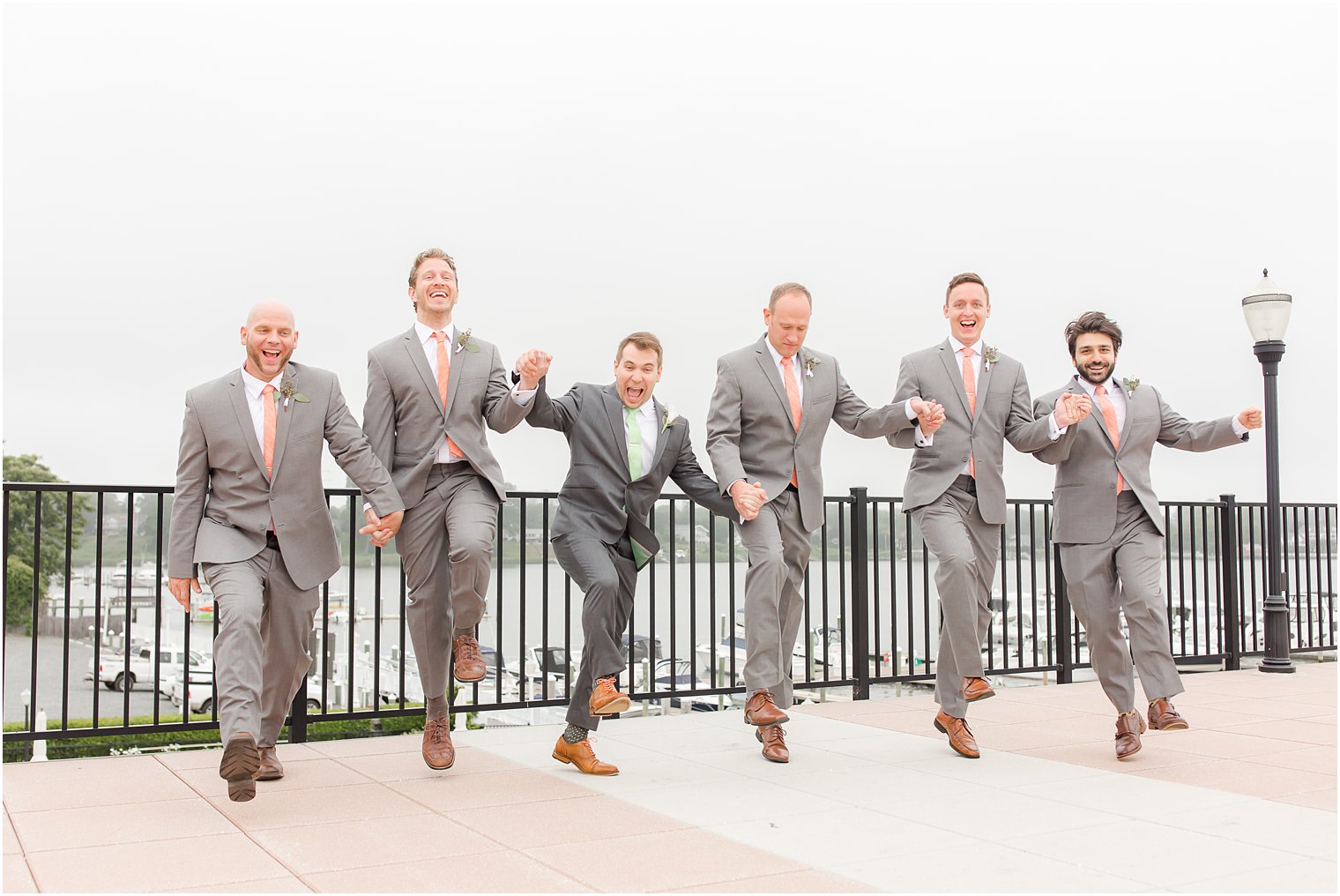 Candid photo of groomsmen jumping