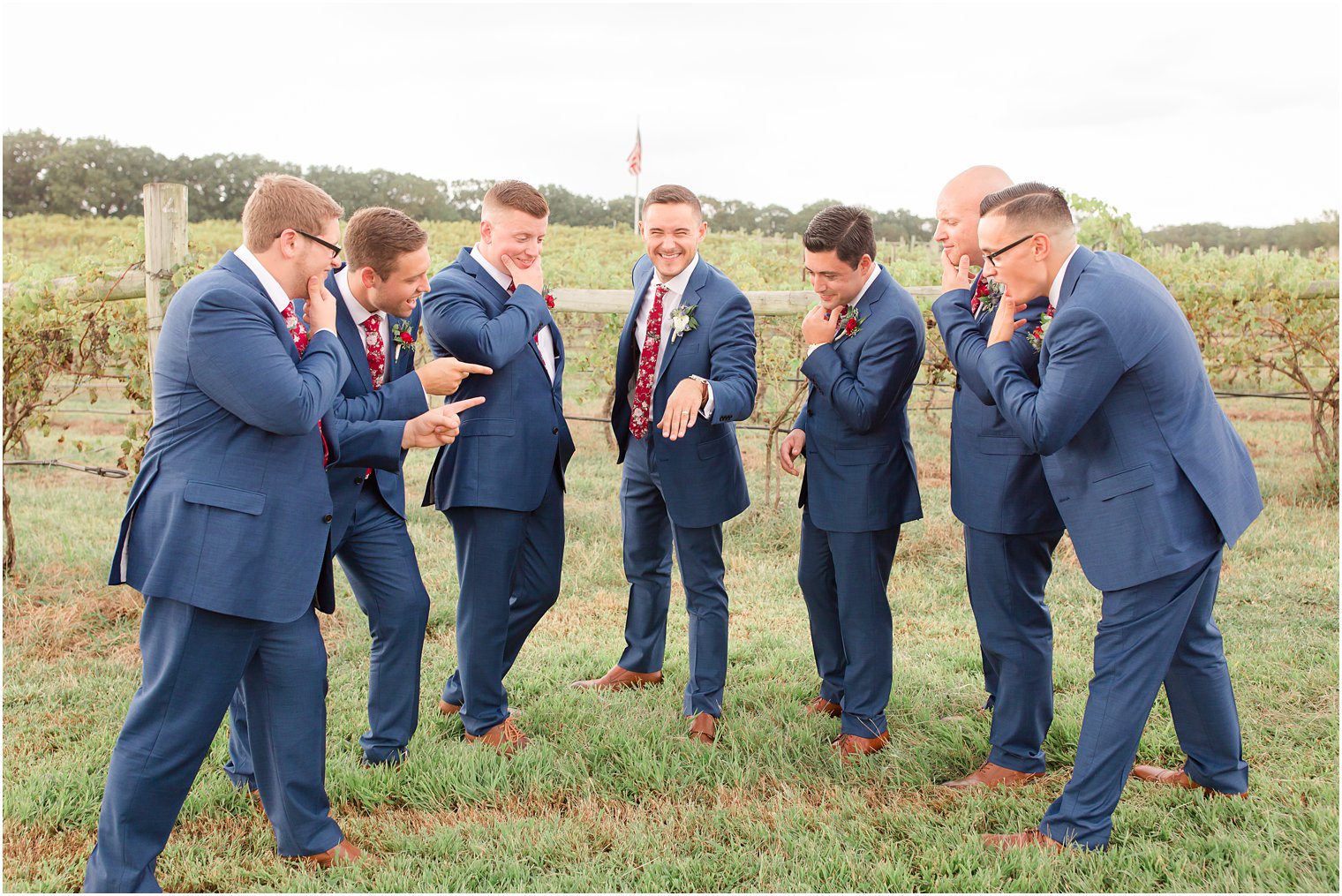Groom showing off his ring to his groomsmen