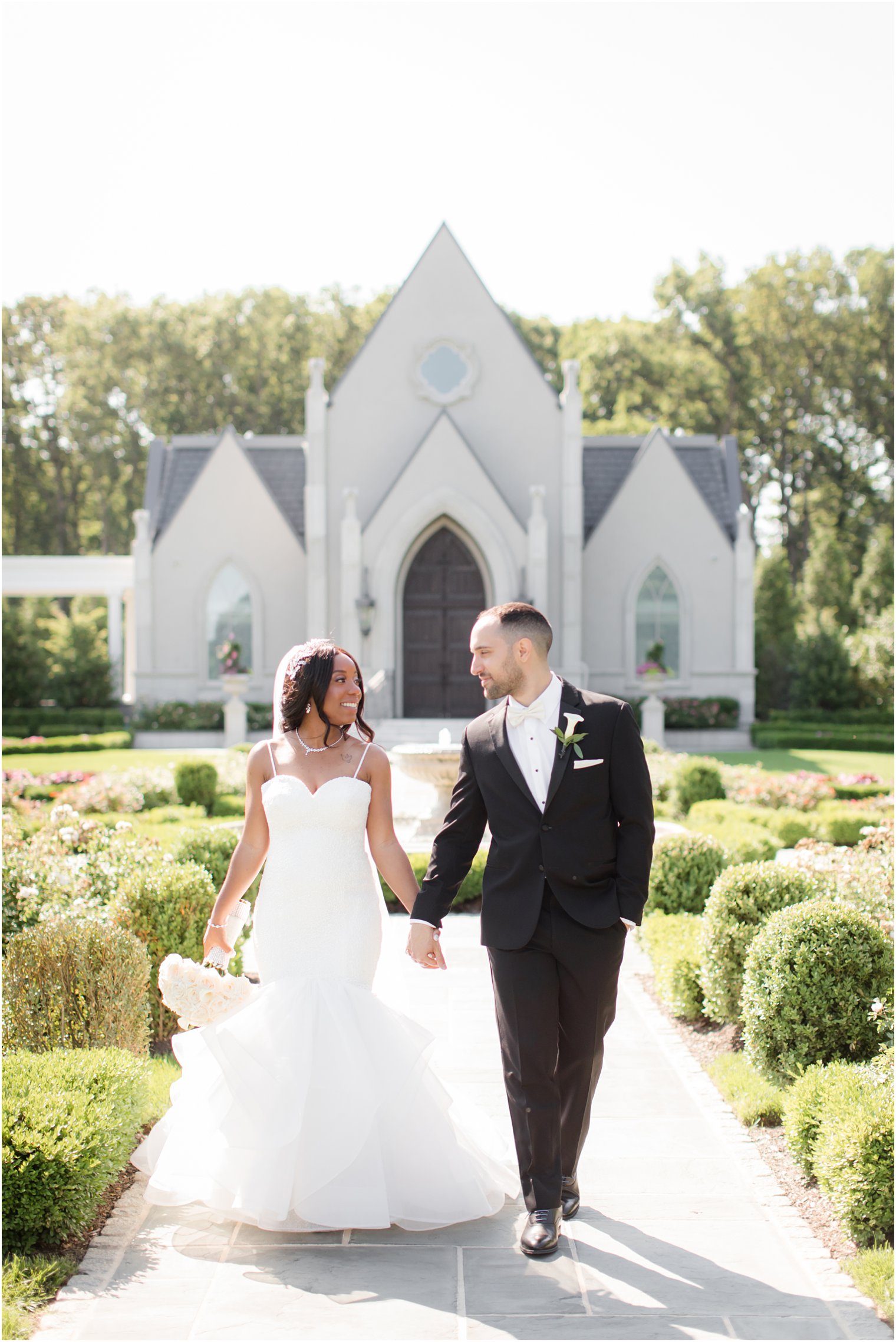 Bride and groom walking | Biracial Wedding at Park Chateau Estate