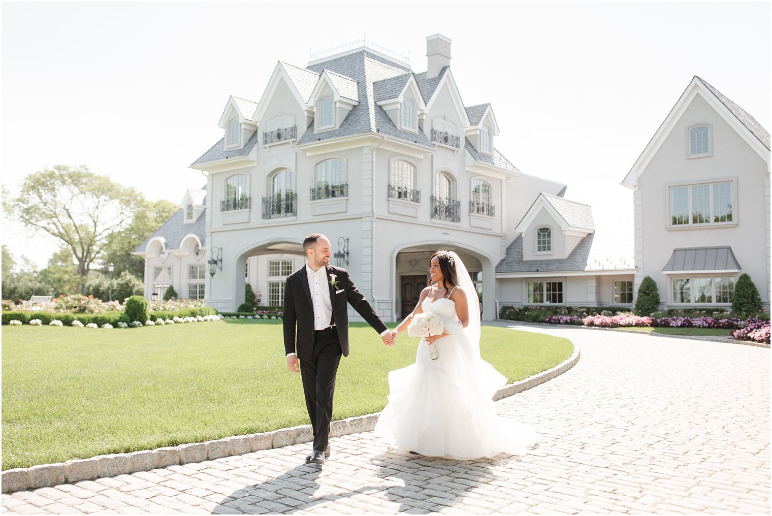 Bride and groom walking at Biracial Wedding at Park Chateau Estate