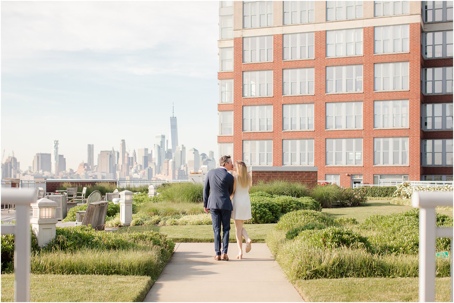 Bride and groom kissing | Hoboken Rooftop Engagement by Idalia Photography