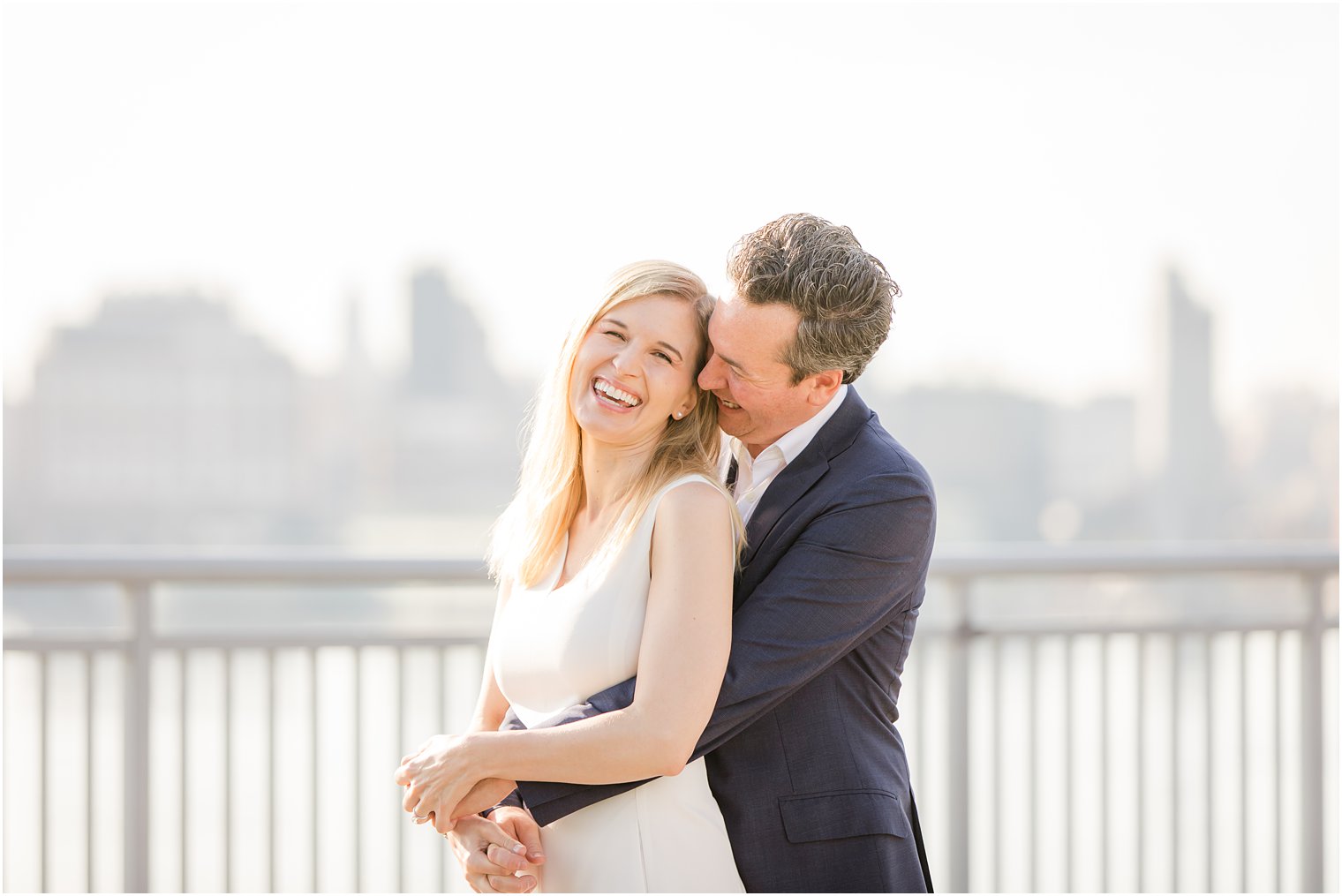 Laughing bride during Hoboken Rooftop Engagement by Idalia Photography