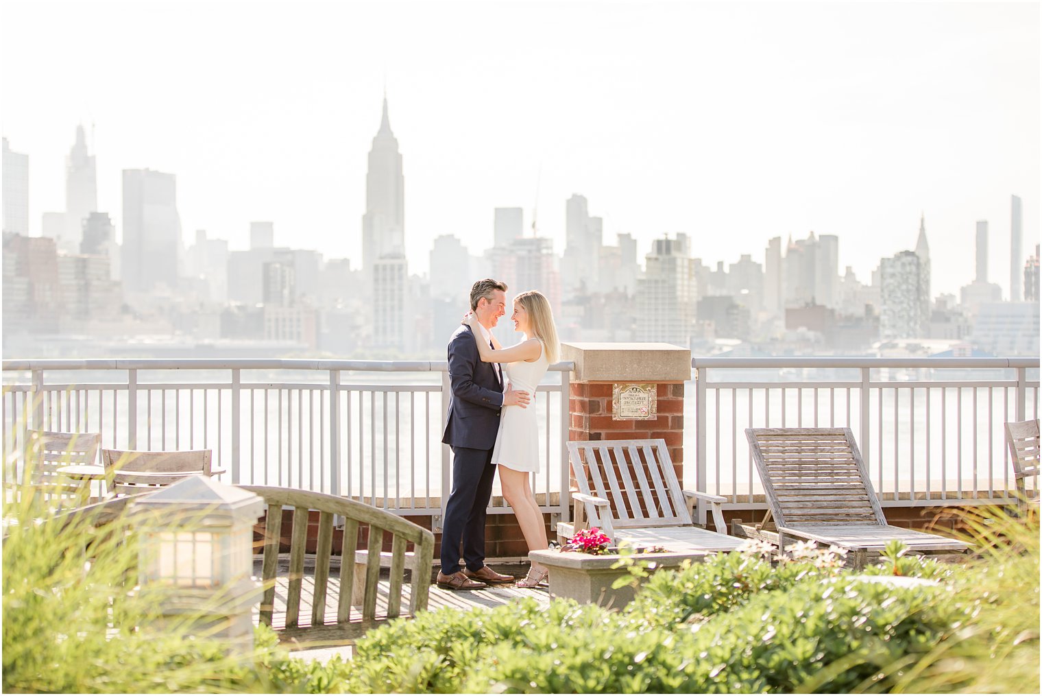 Bride and groom hugging during Hoboken Rooftop Engagement by Idalia Photography