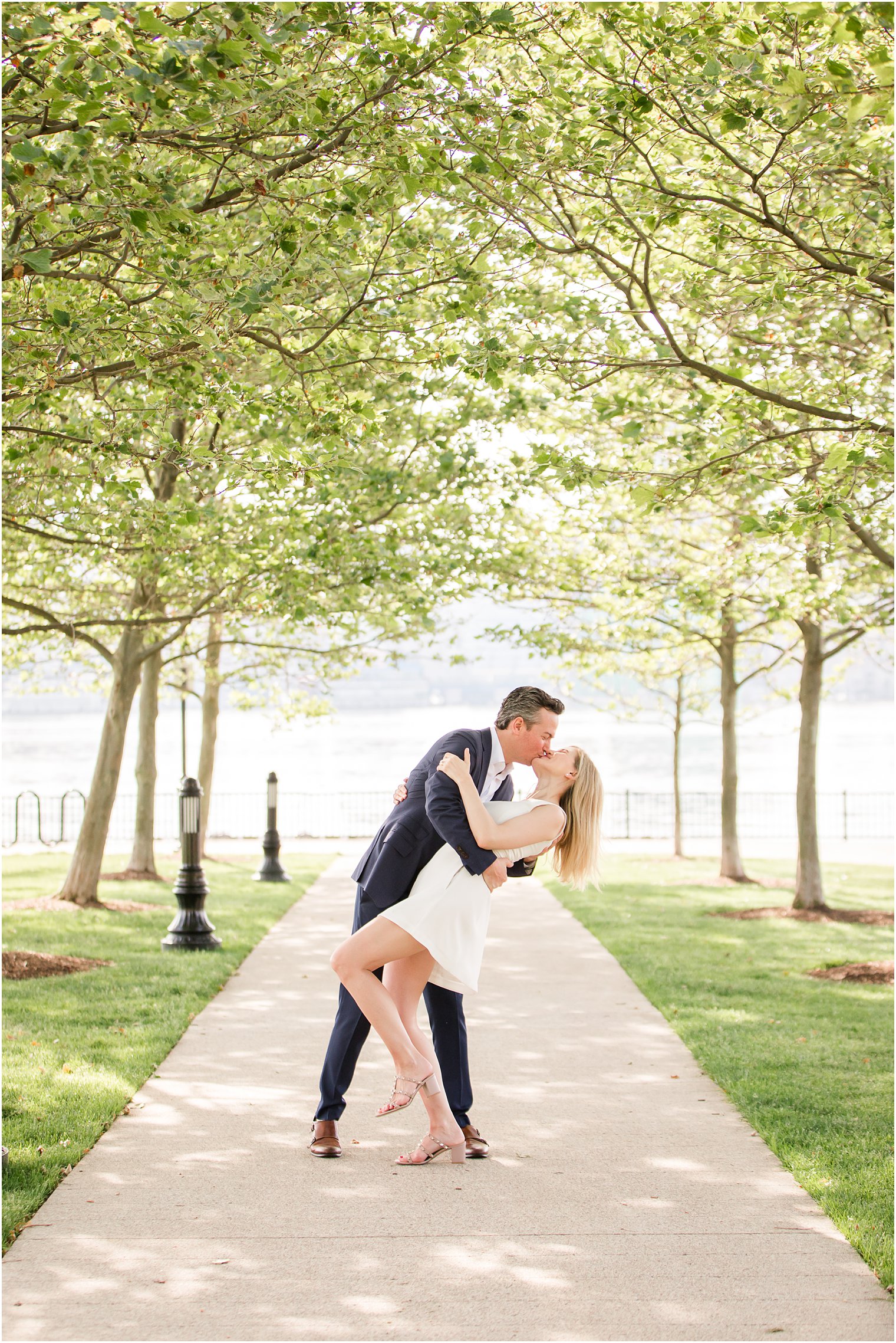 Groom dipping bride during romantic kiss at Engagement photos at Hoboken park