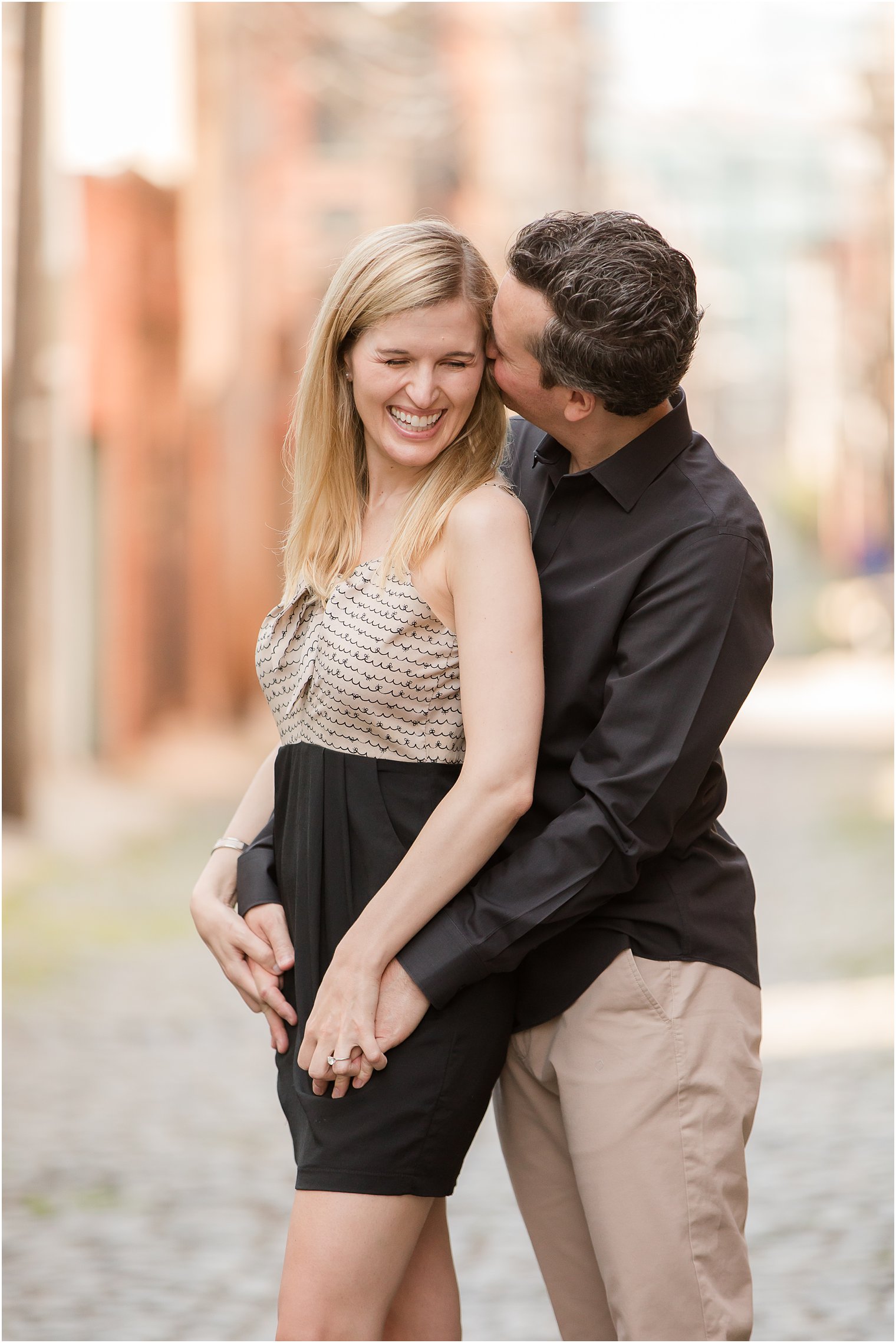 Candid photo of groom making bride laugh 