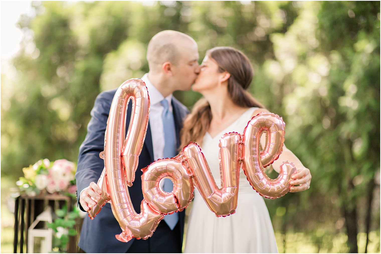 photo of married couple with love balloon | NJ backyard wedding by Idalia Photography