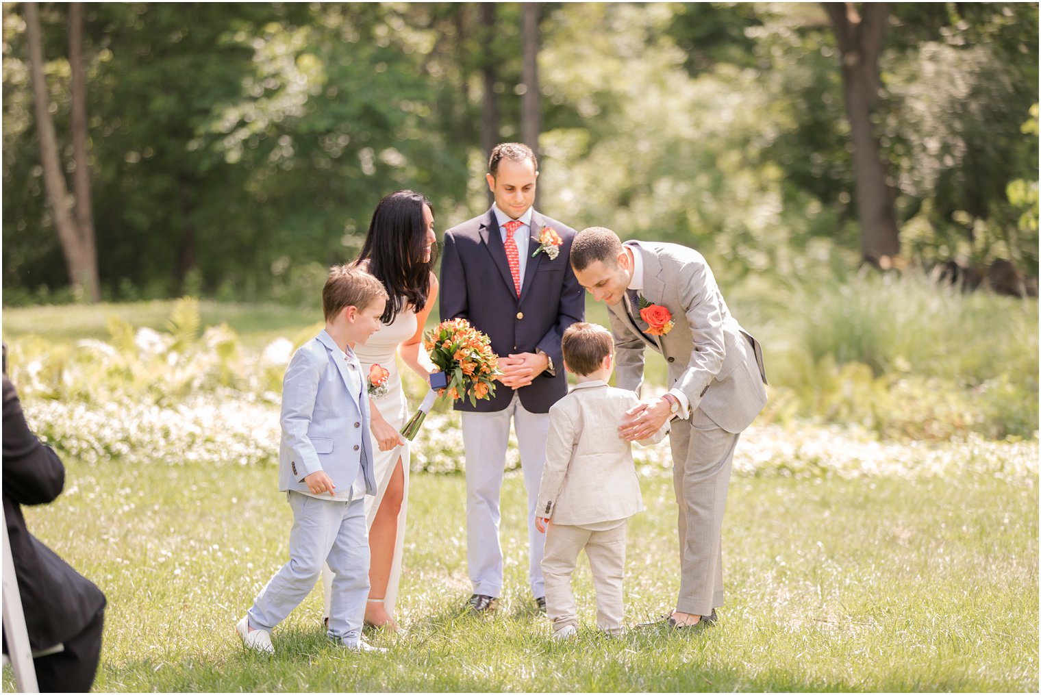 Ring bearers giving groom the wedding rings