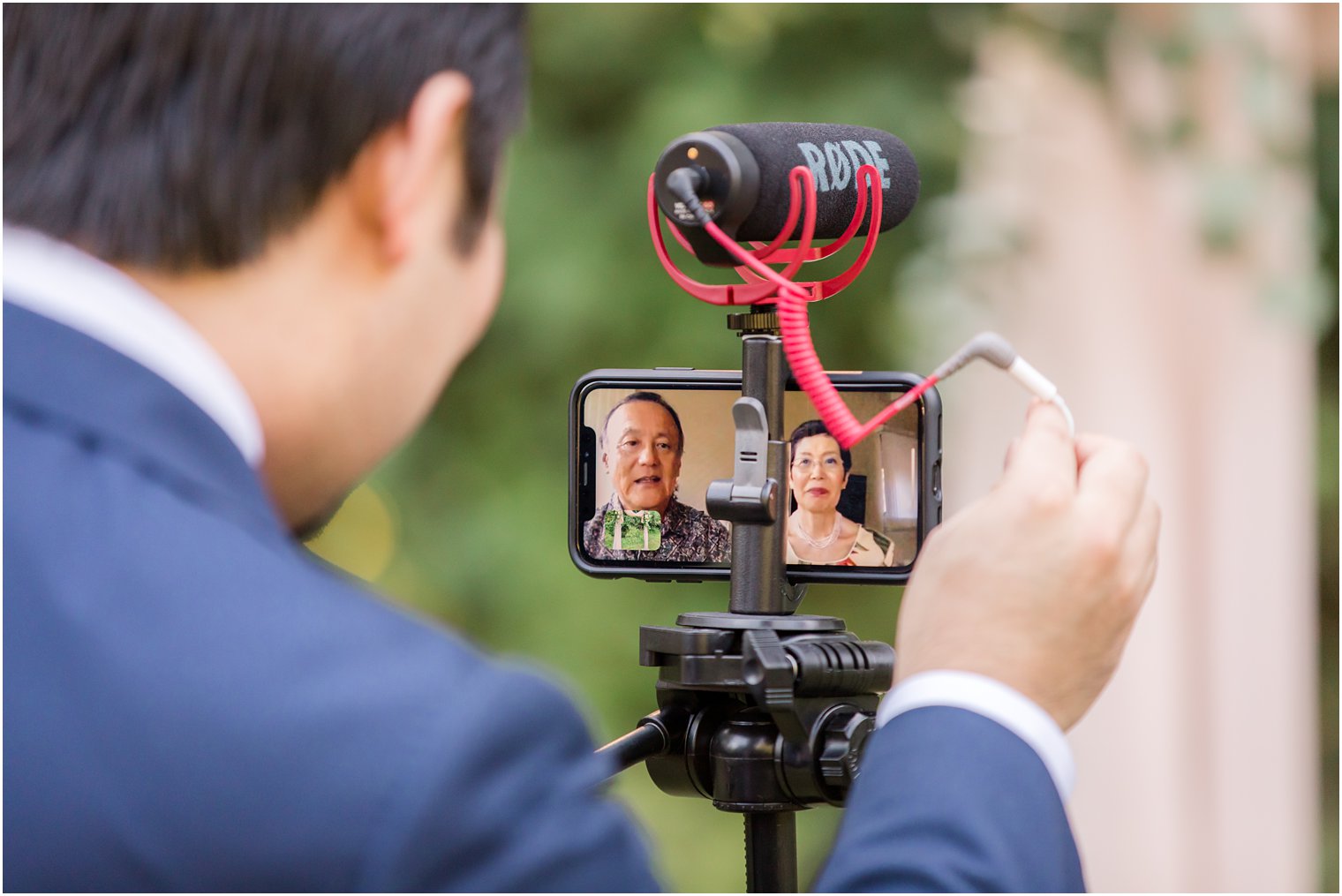 Groom's parents in Zoom call during intimate wedding