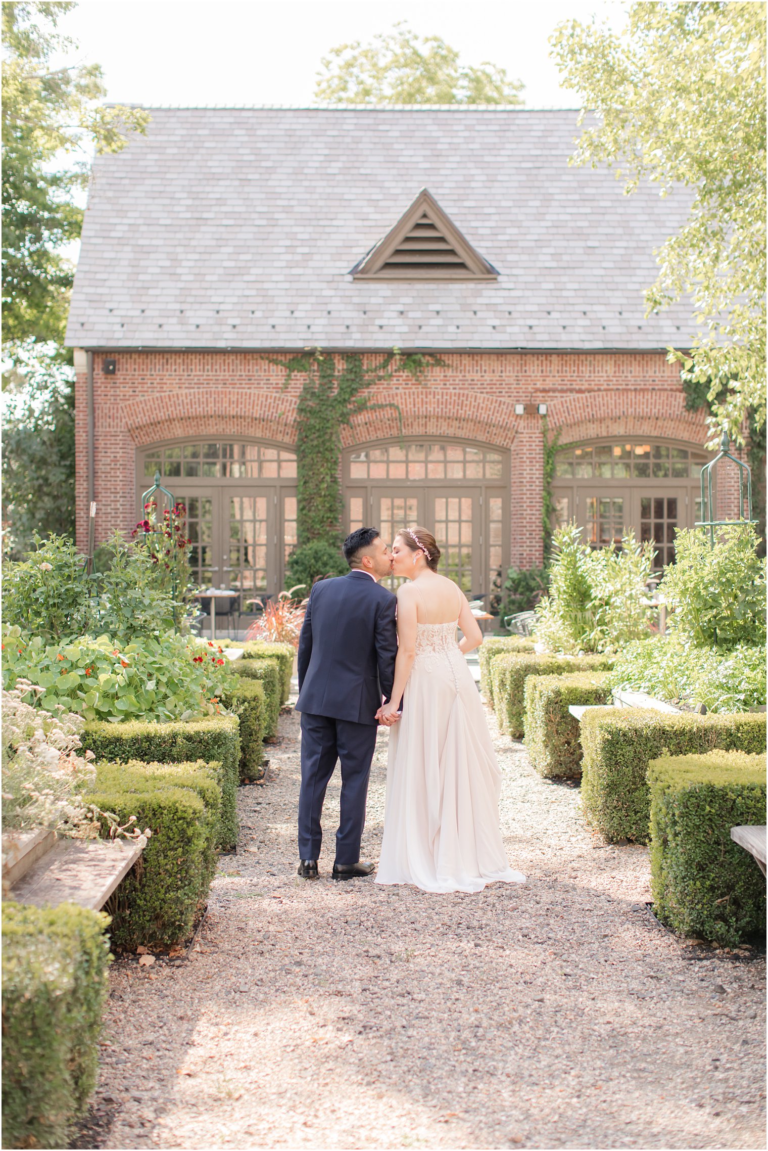 Bride and groom walking in the courtyard at Ninety Acres