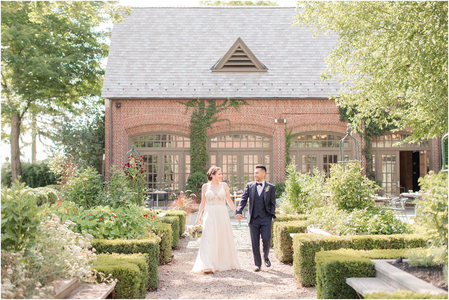 Bride and groom walking in courtyard at Ninety Acres at Natirar wedding