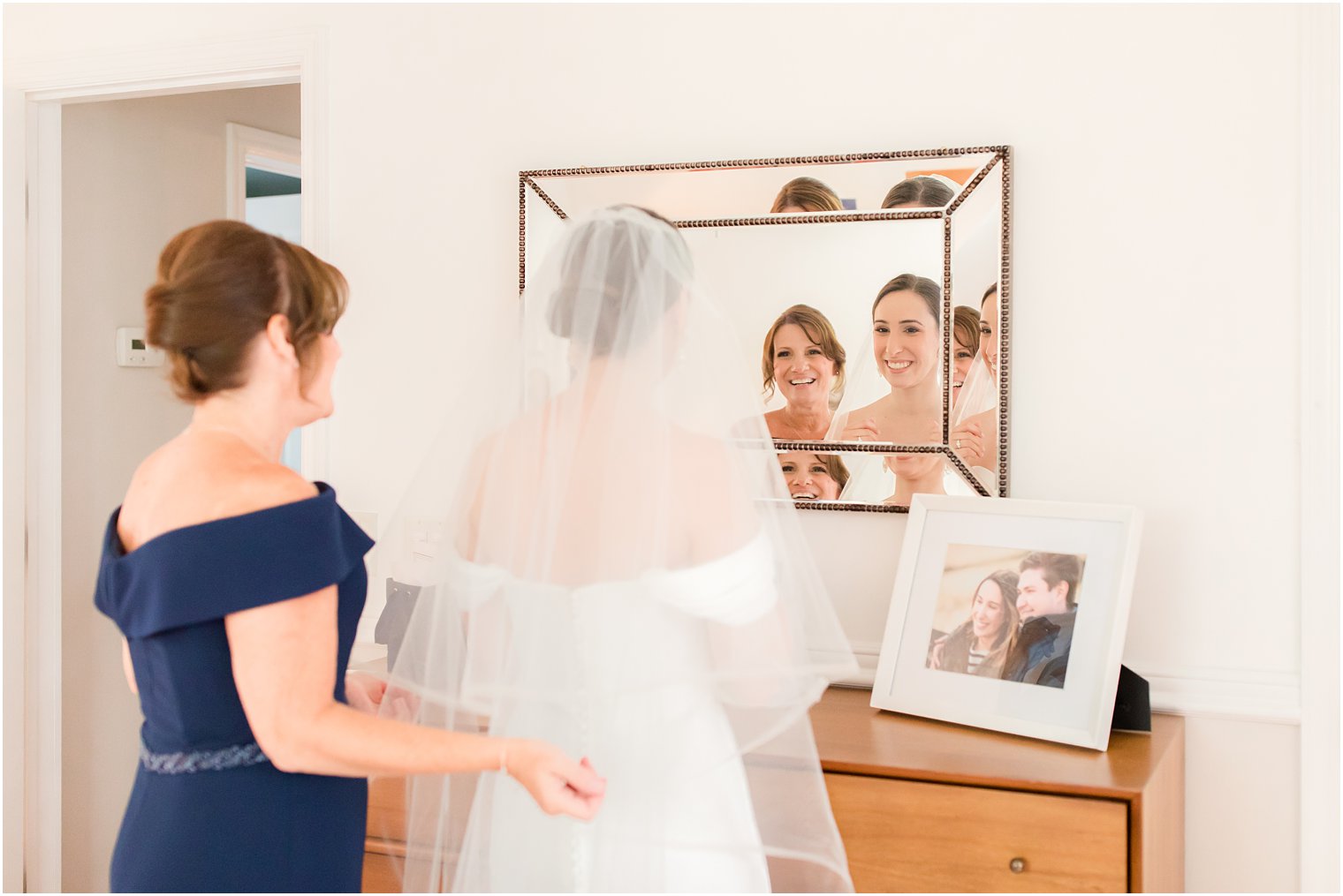 mother of bride putting on her veil