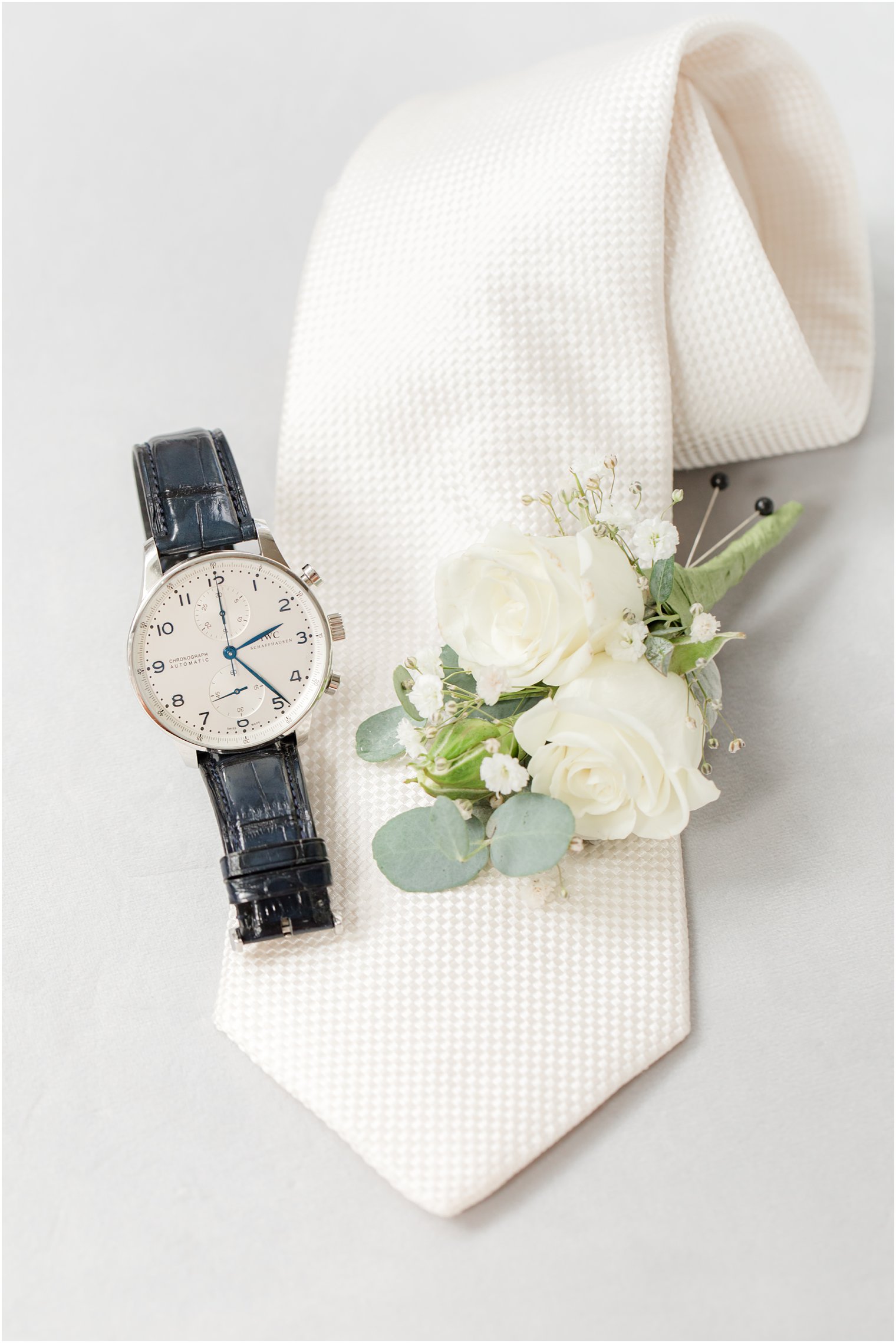 groom's watch, tie, and boutonniere