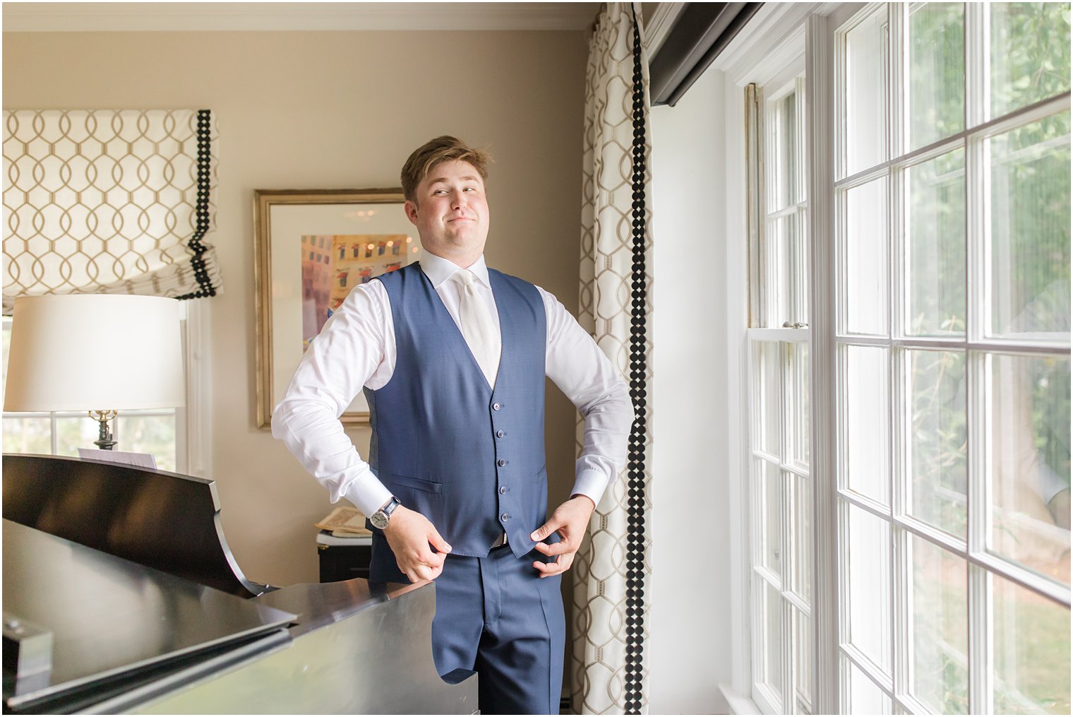 groom putting on his vest