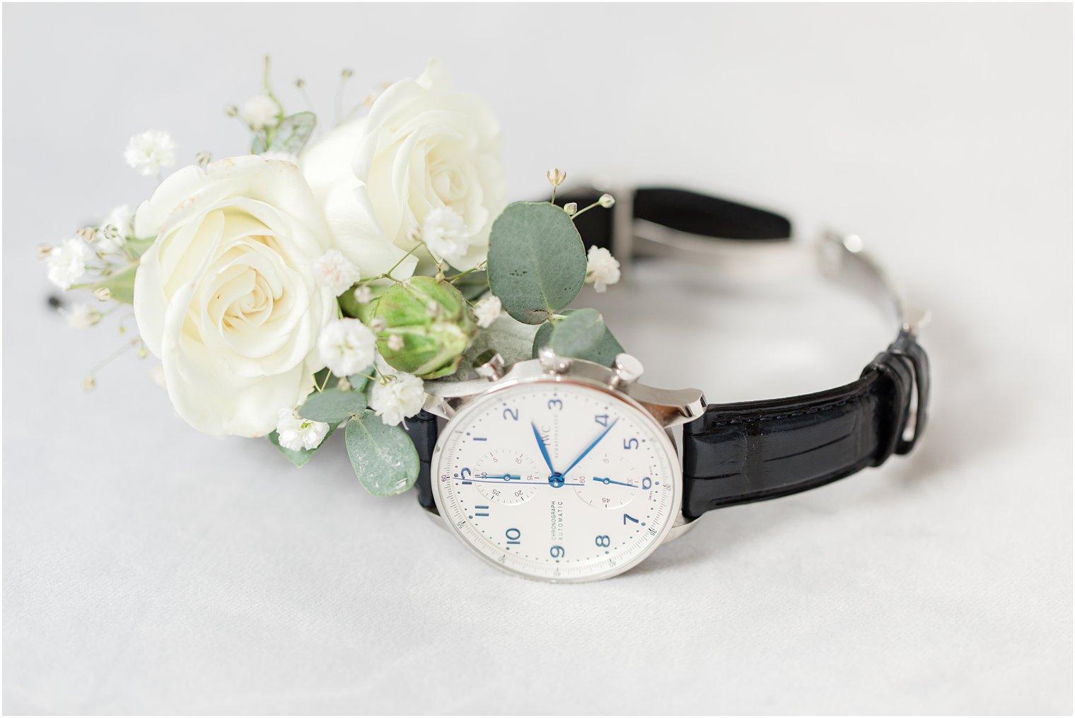 groom's watch with black leather band and boutonniere