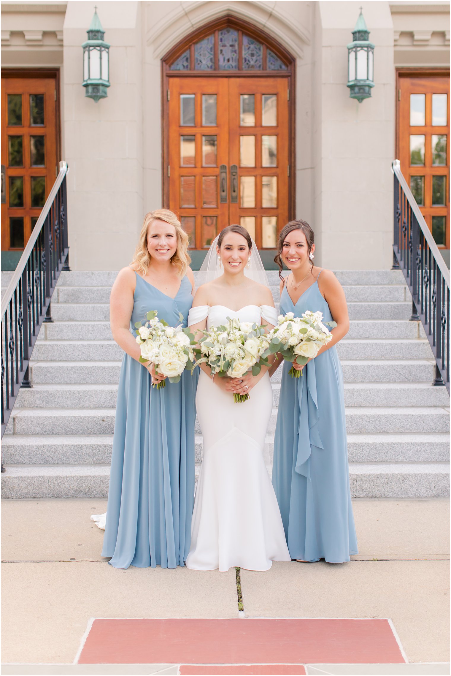 bridesmaids wearing blue at wedding ceremony at Our Lady of Mount Carmel in Ridgewood NJ