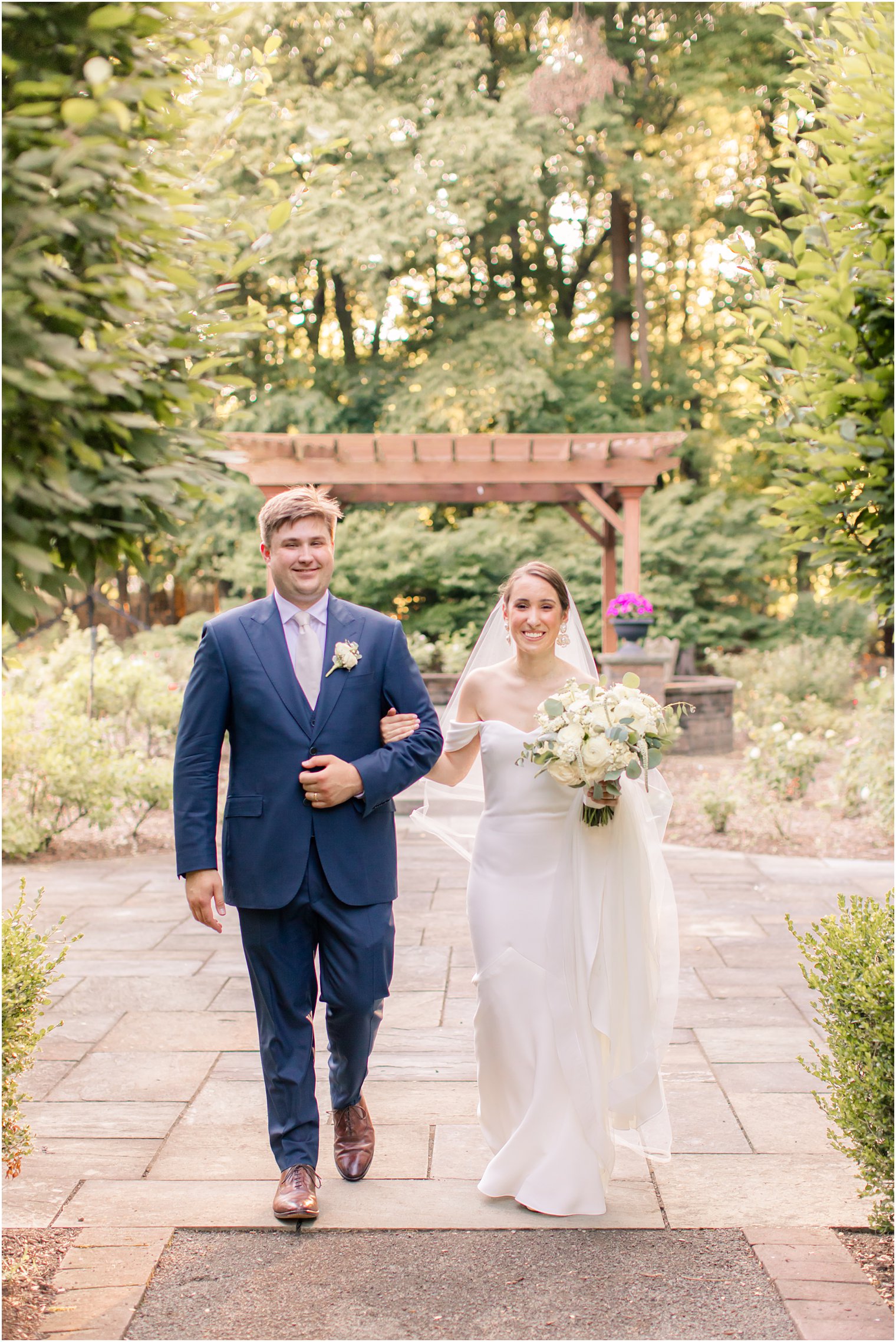 bride and groom walking at the Gardens of Wyckoff 