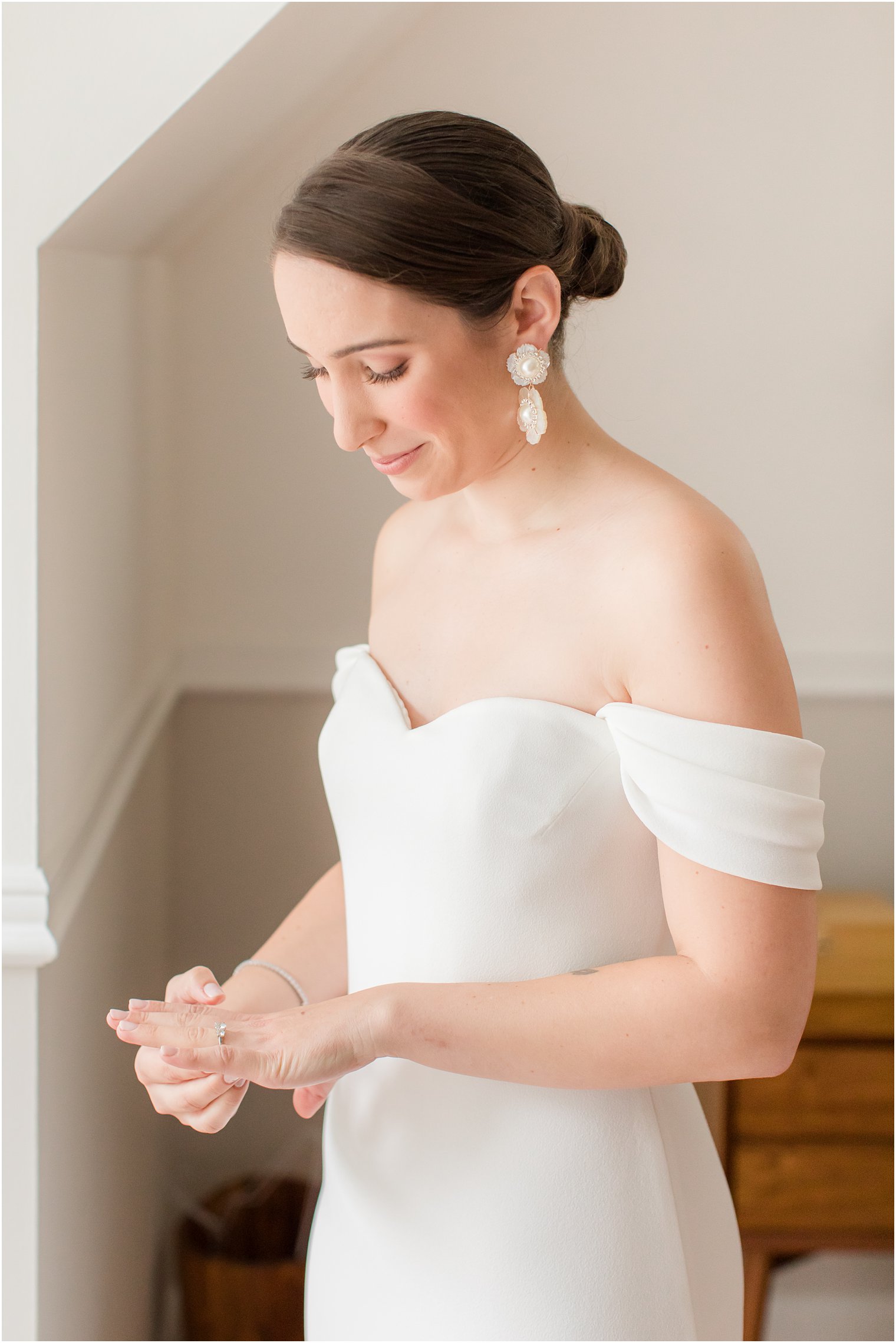 bride putting on her engagement ring