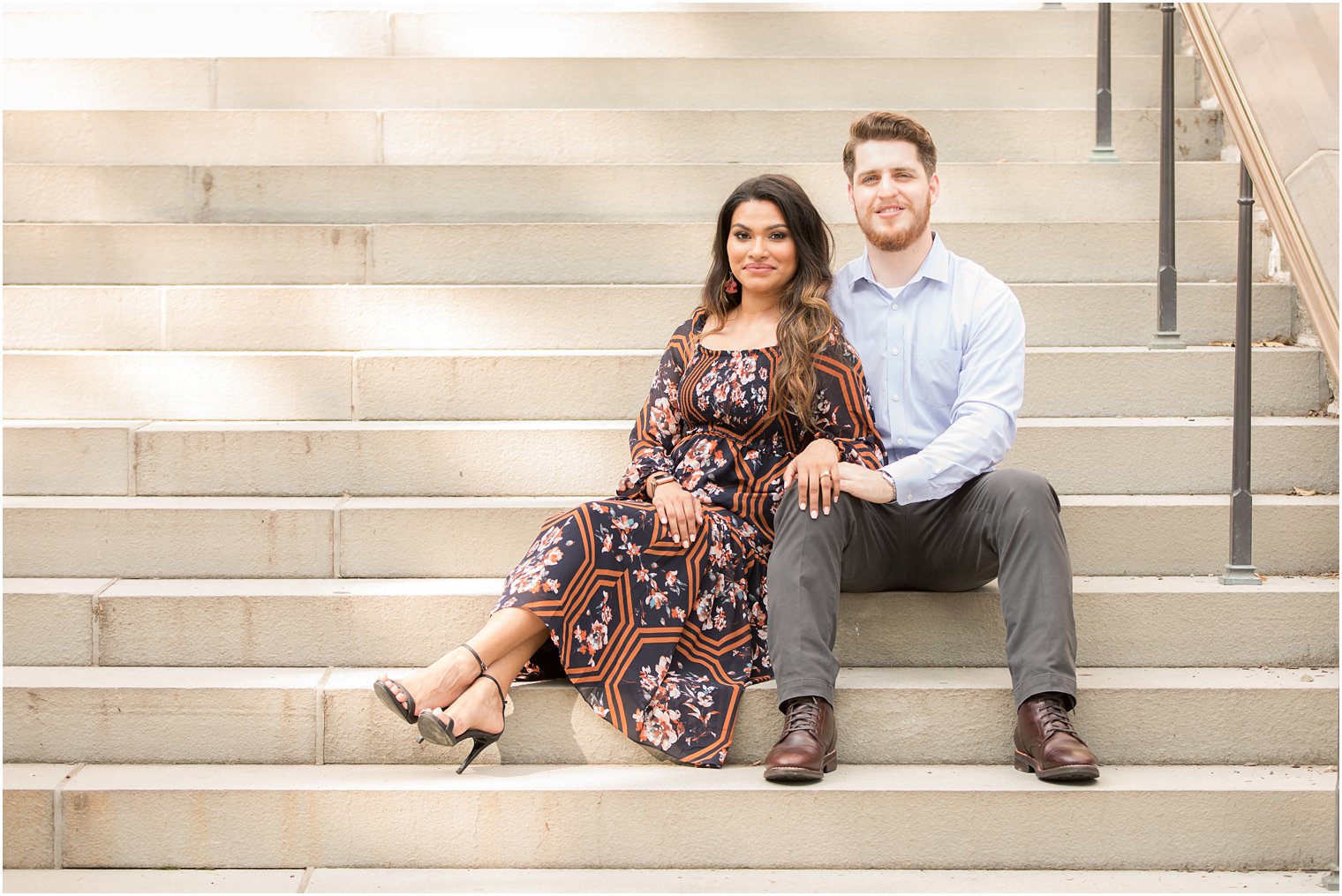 Engaged couple sitting on steps