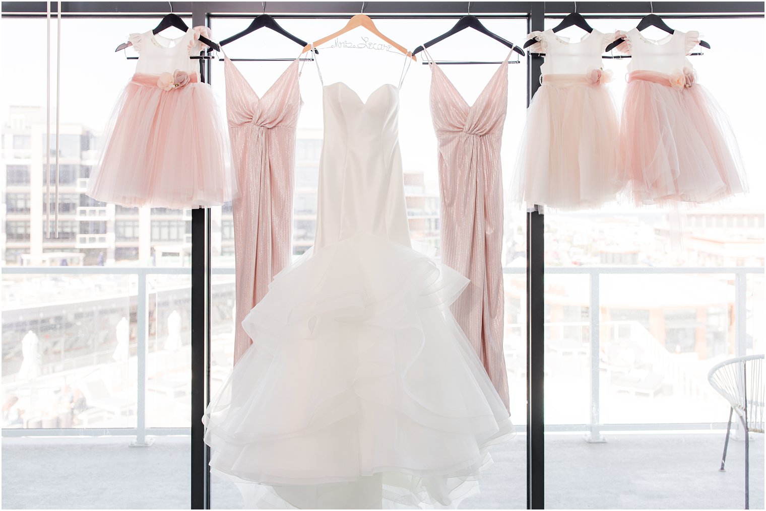 bridesmaid dresses hang with flower girl dresses and bridal gown at Wave Resort 