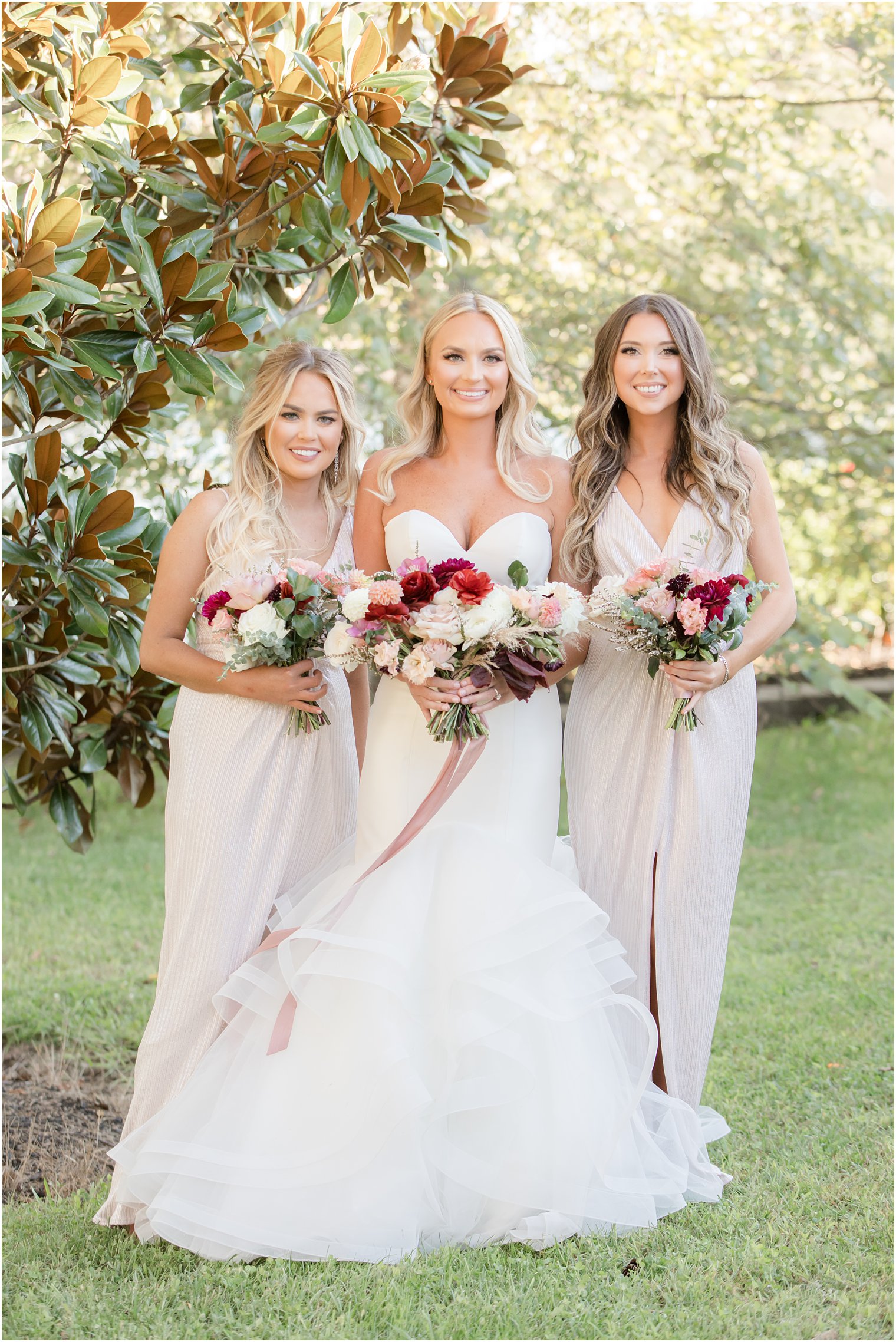 bride poses with two bridesmaids before Windows on the Water at Frogbridge wedding