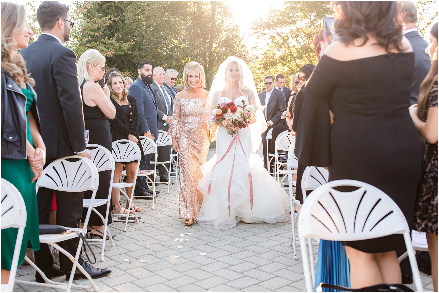 Bride walking down the aisle with her mother