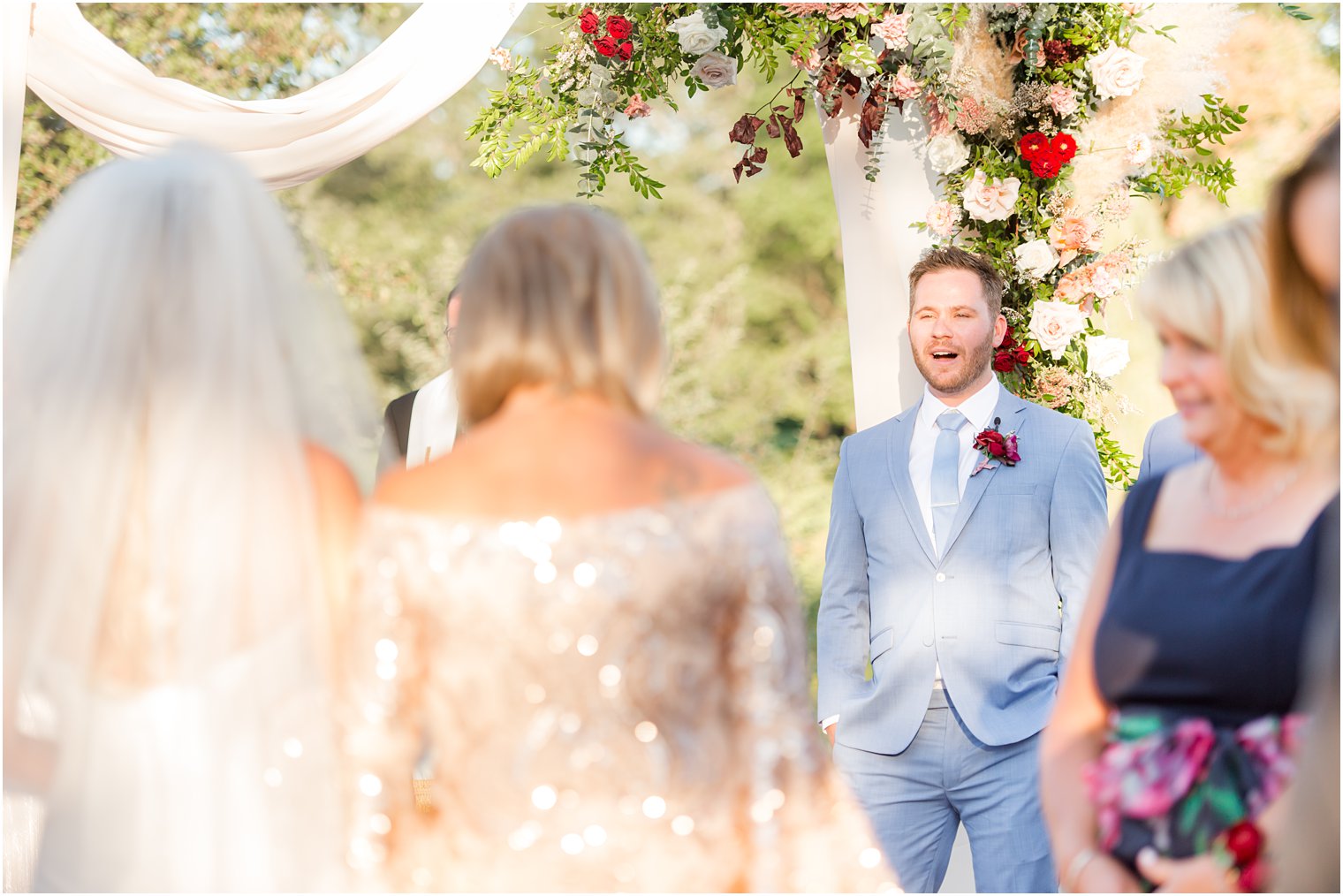 groom reacts to seeing bride walk down aisle at Windows on the Water at Frogbridge