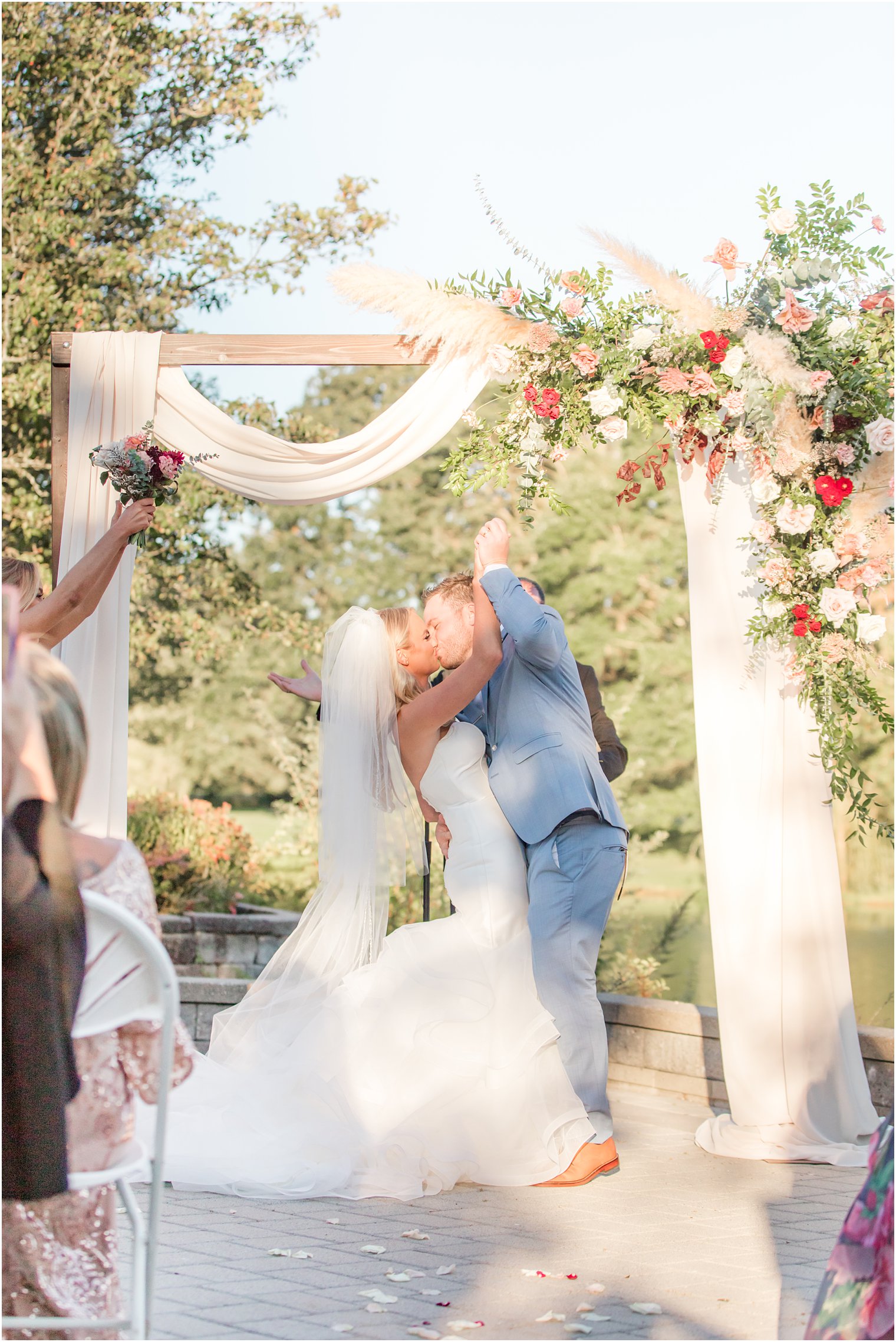 groom cheers during first kiss at New Jersey wedding ceremony