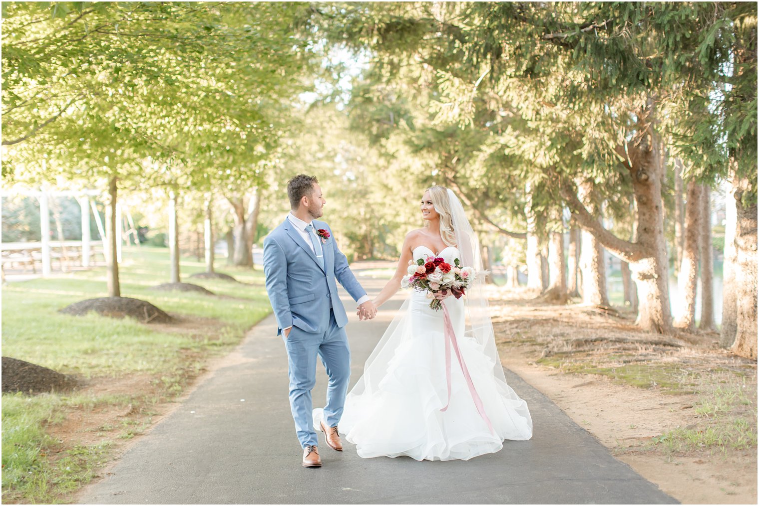 bride and groom walk at Windows on the Water at Frogbridge