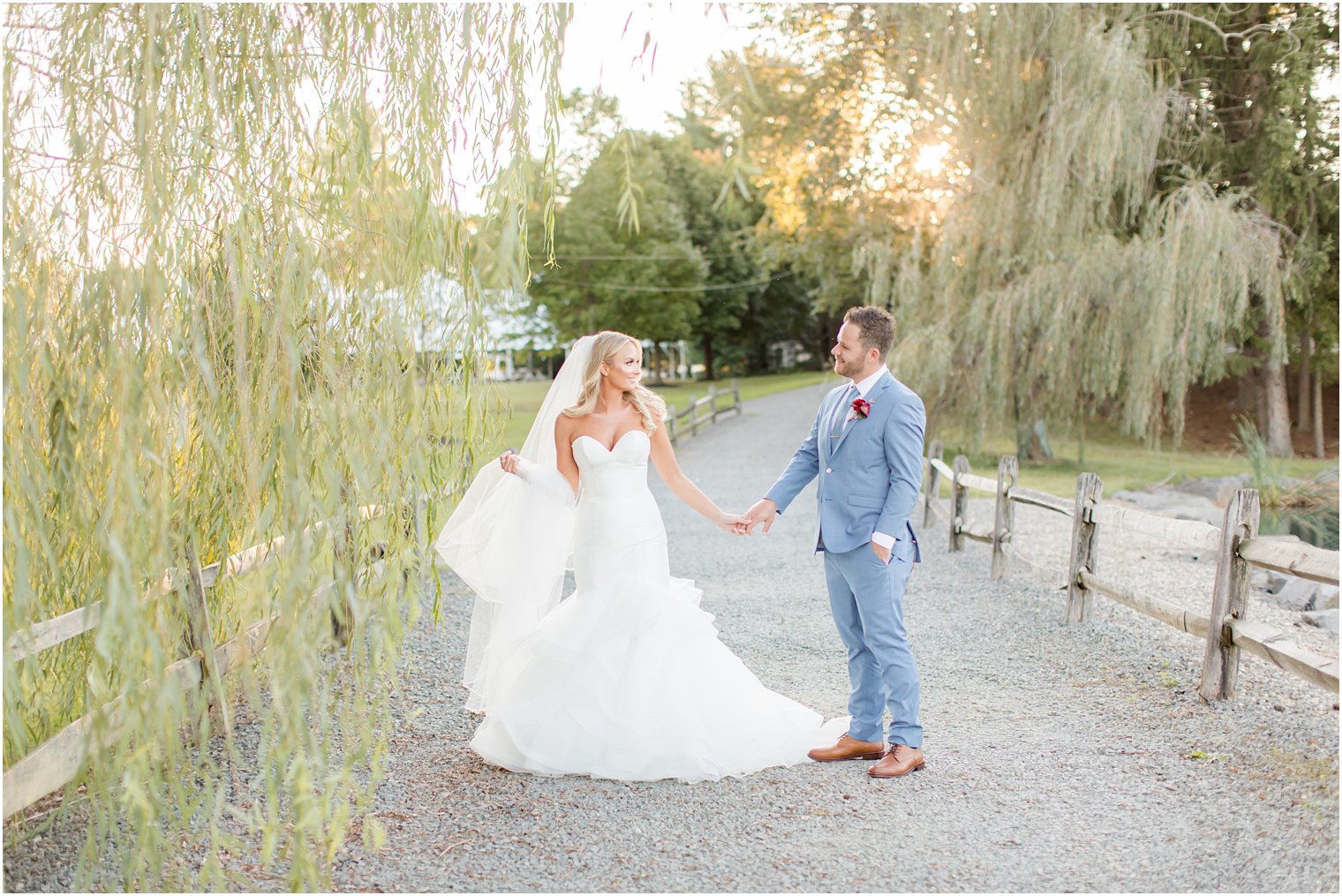 sunset newlywed portraits by willow tree at Windows on the Water at Frogbridge