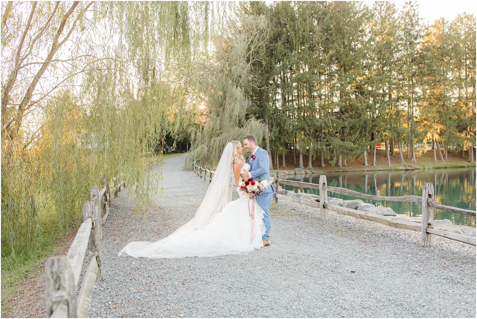 Windows on the Water at Frogbridge wedding portraits of bride and groom by lake