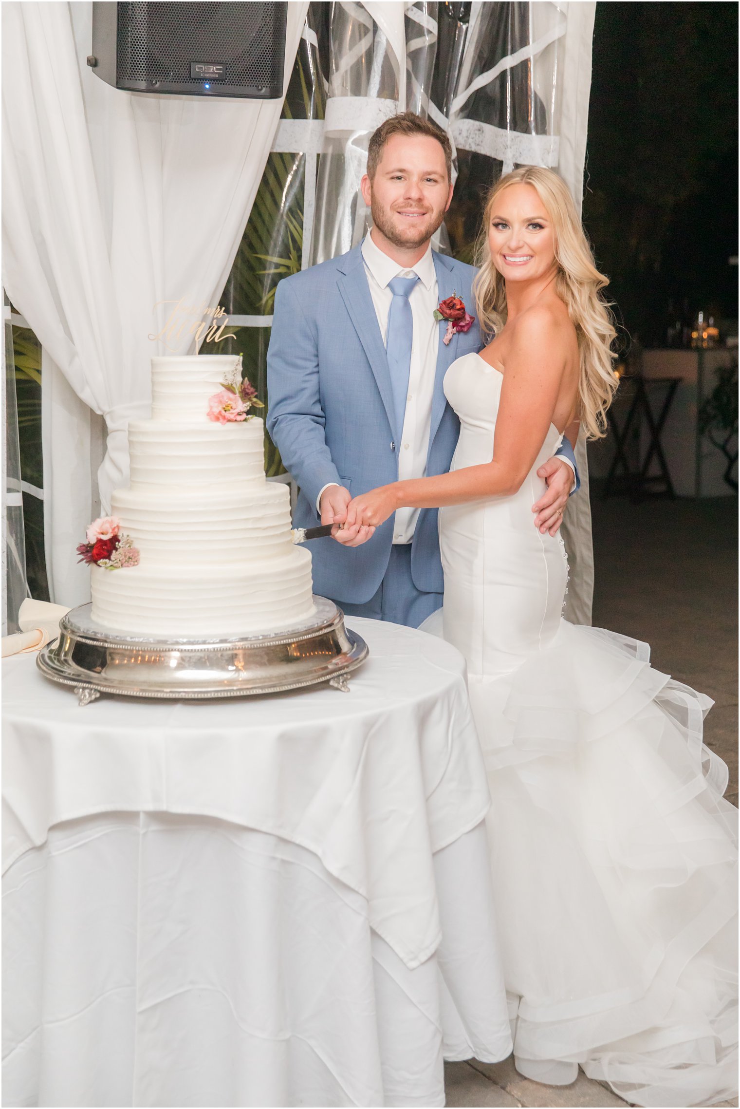 newlyweds prepare to cut wedding cake at New Jersey wedding reception