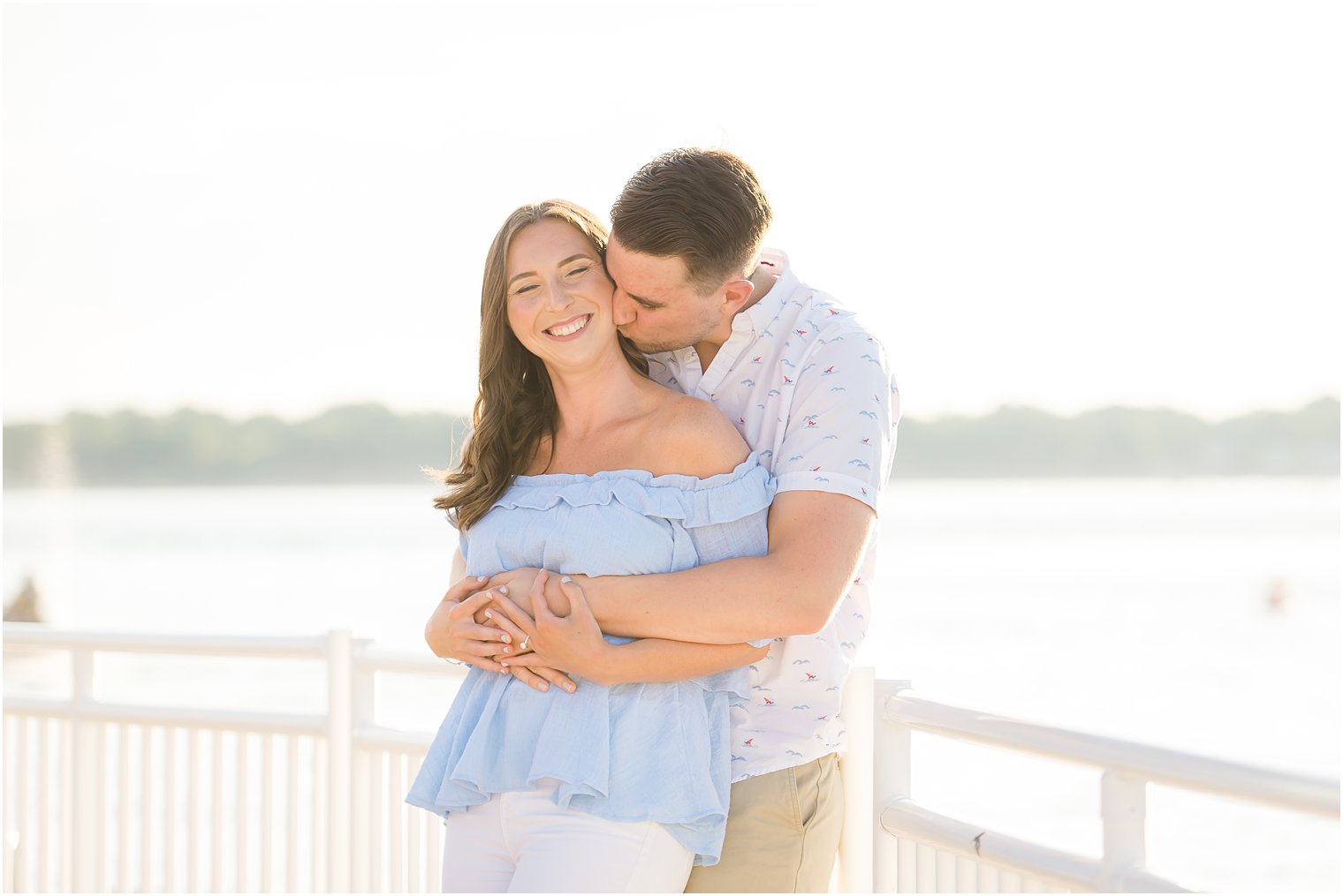 groom kisses bride on the cheek during Belmar NJ Engagement Session