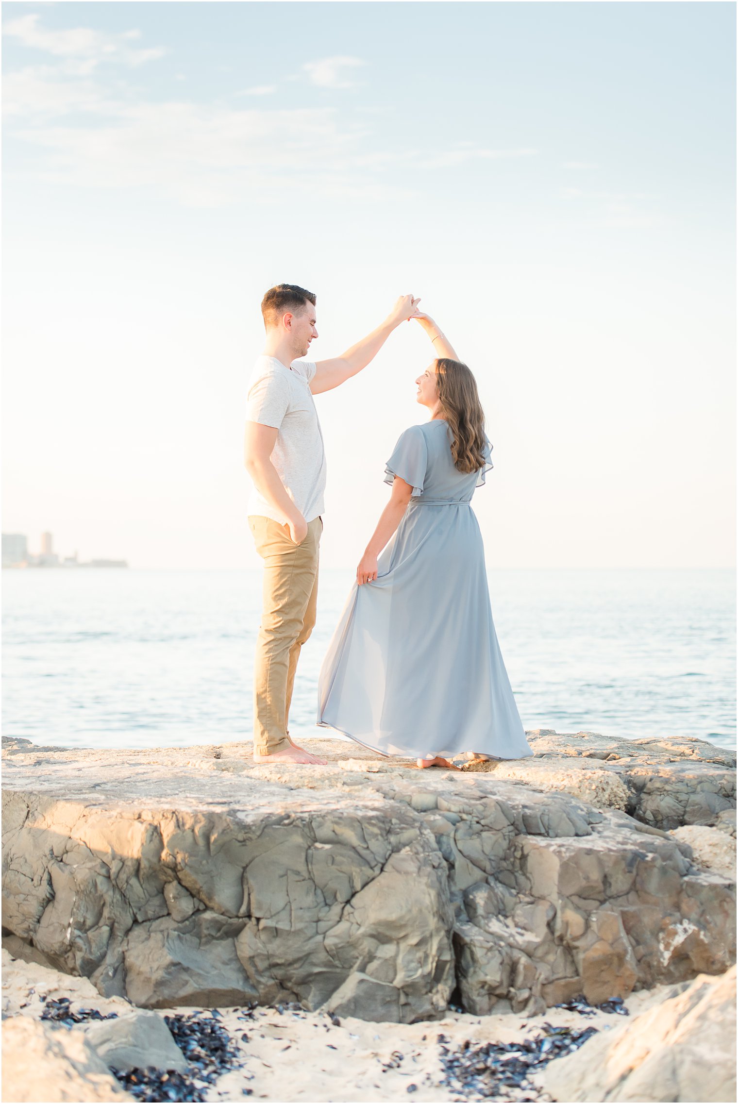 groom twirls bride during NJ engagement portraits