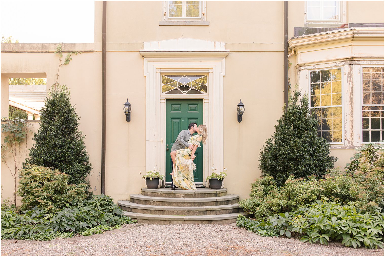 engaged couple poses in front of New Jersey door